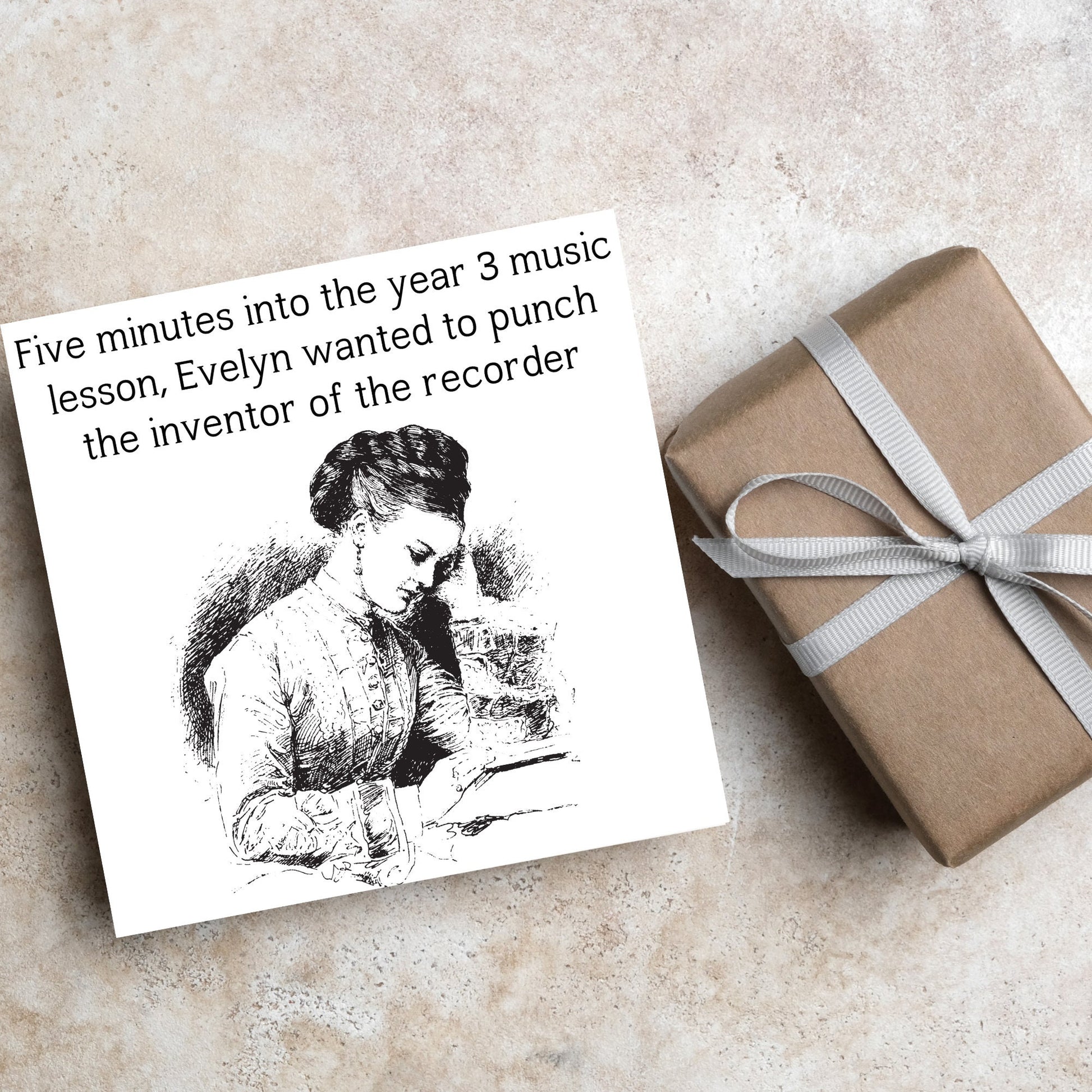 Image of a square greetings card with a black and white line drawing of a victorian lady sitting at a desk with her head in her hands and the text - five minutes into the tear 3 music lesson, evelyn wanted to punch the inventor of the recorder