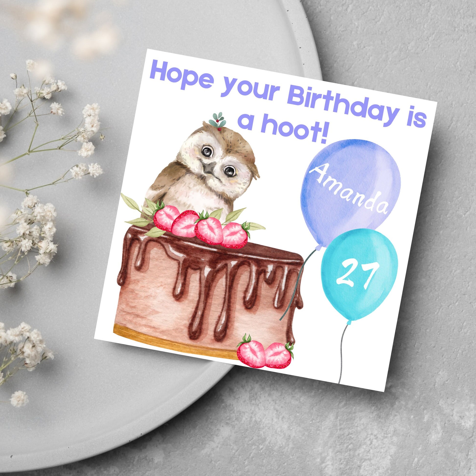 square birthday card with a cute owl sitting on a chocolate cake with the text hope our birthday is a hoot. next to the owl are two blue balloons, one with the name of the person and one with the age in white writing