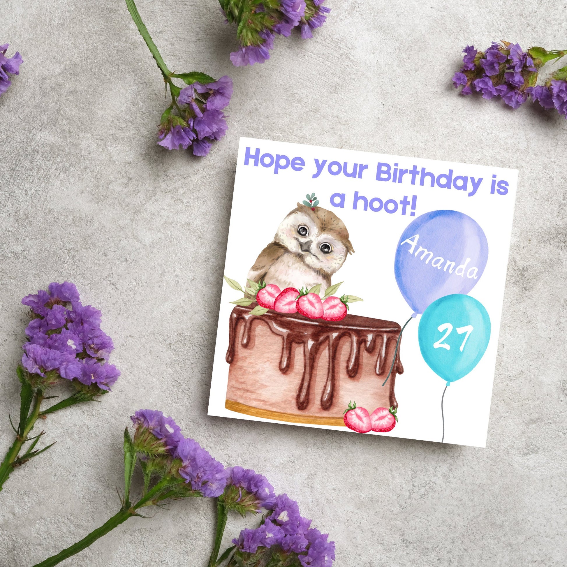 square birthday card with a cute owl sitting on a chocolate cake with the text hope our birthday is a hoot. next to the owl are two blue balloons, one with the name of the person and one with the age in white writing