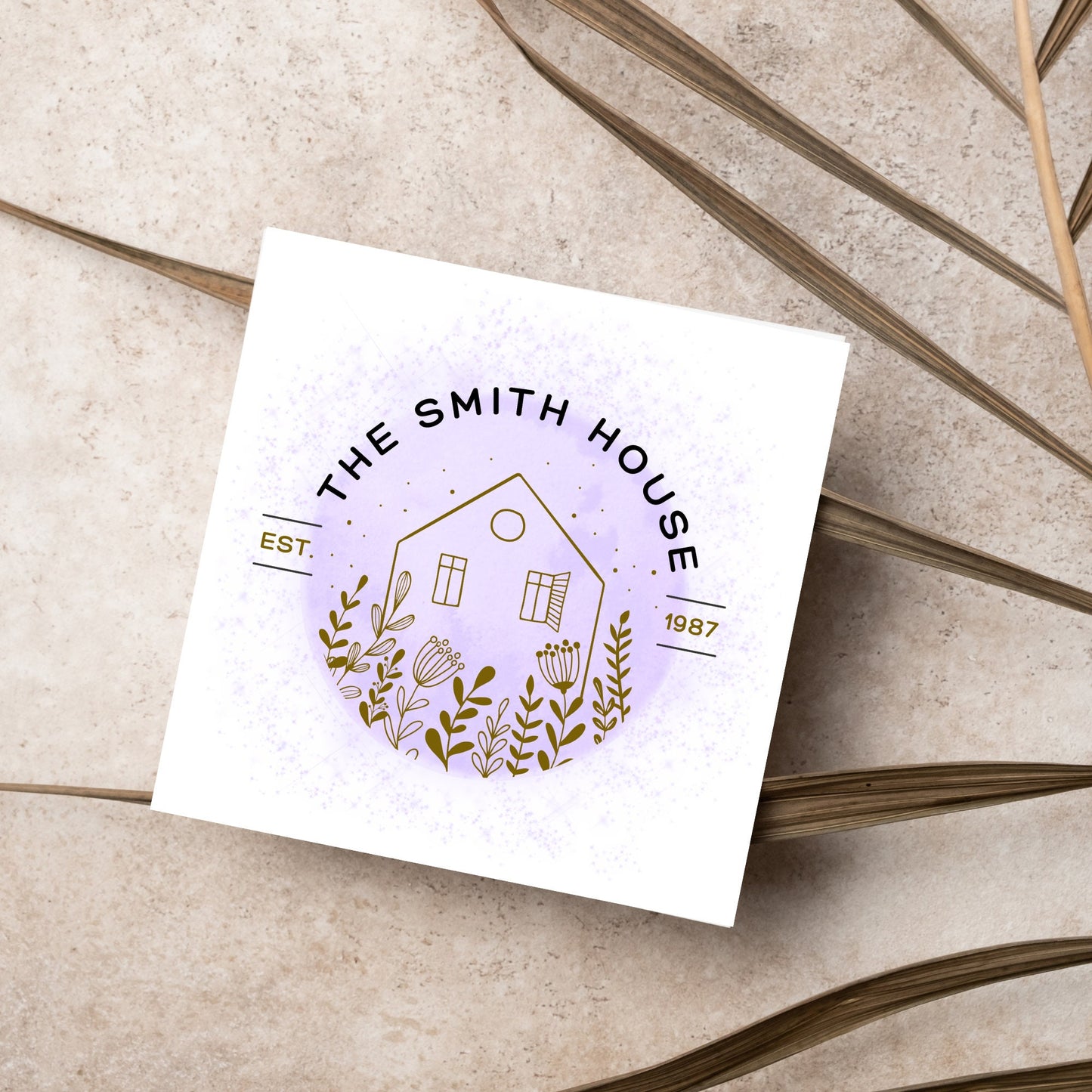 square card with a purple watercolour circle with a line drawing of a house and foliage over it. Arched text reads the smith house on top with est 1987 running through the centre