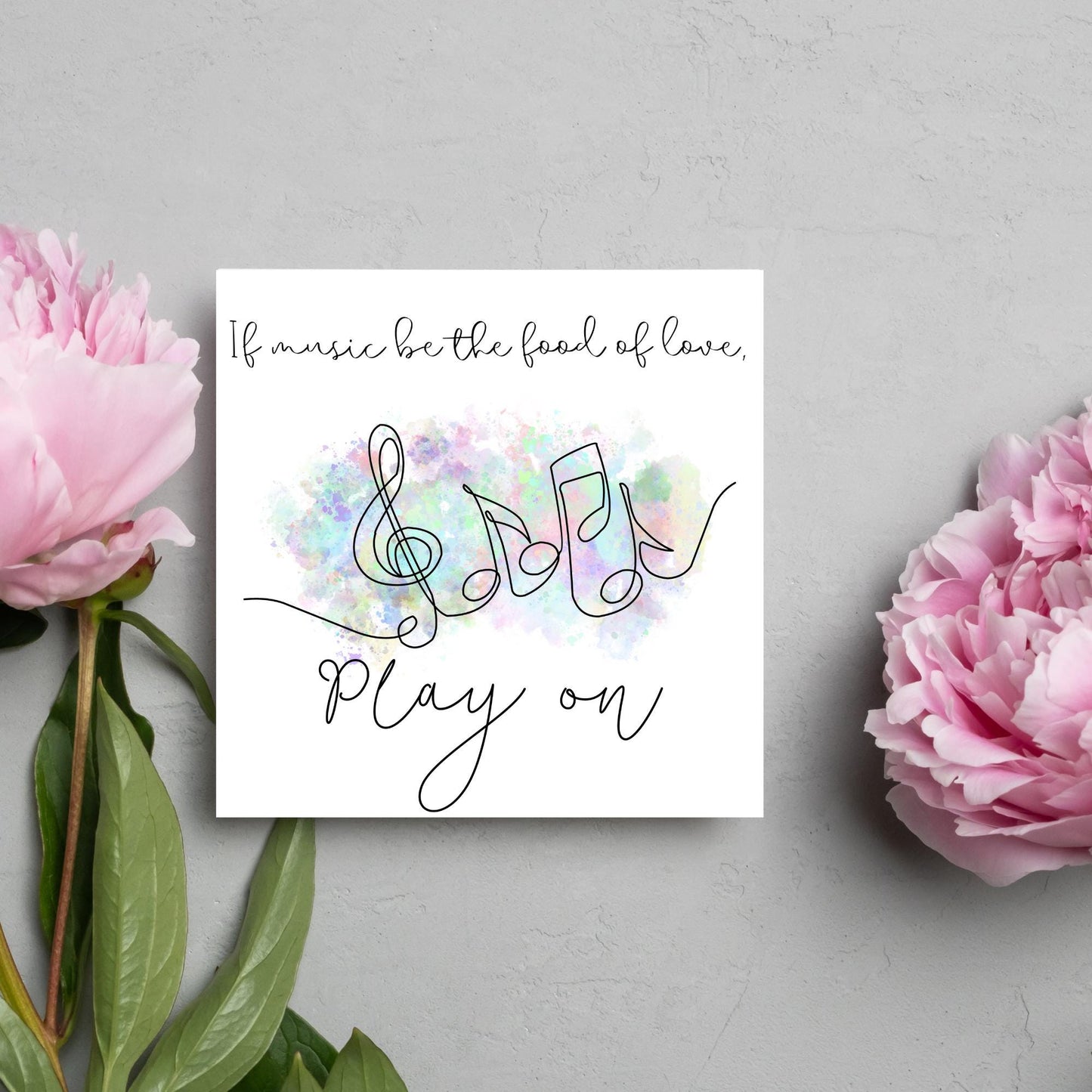 White square card with a one line drawing of musical notes that look like they are dancing in front of a pastel rainbow watercolour cloud. Cursive text reads, If music be the food of love, play on