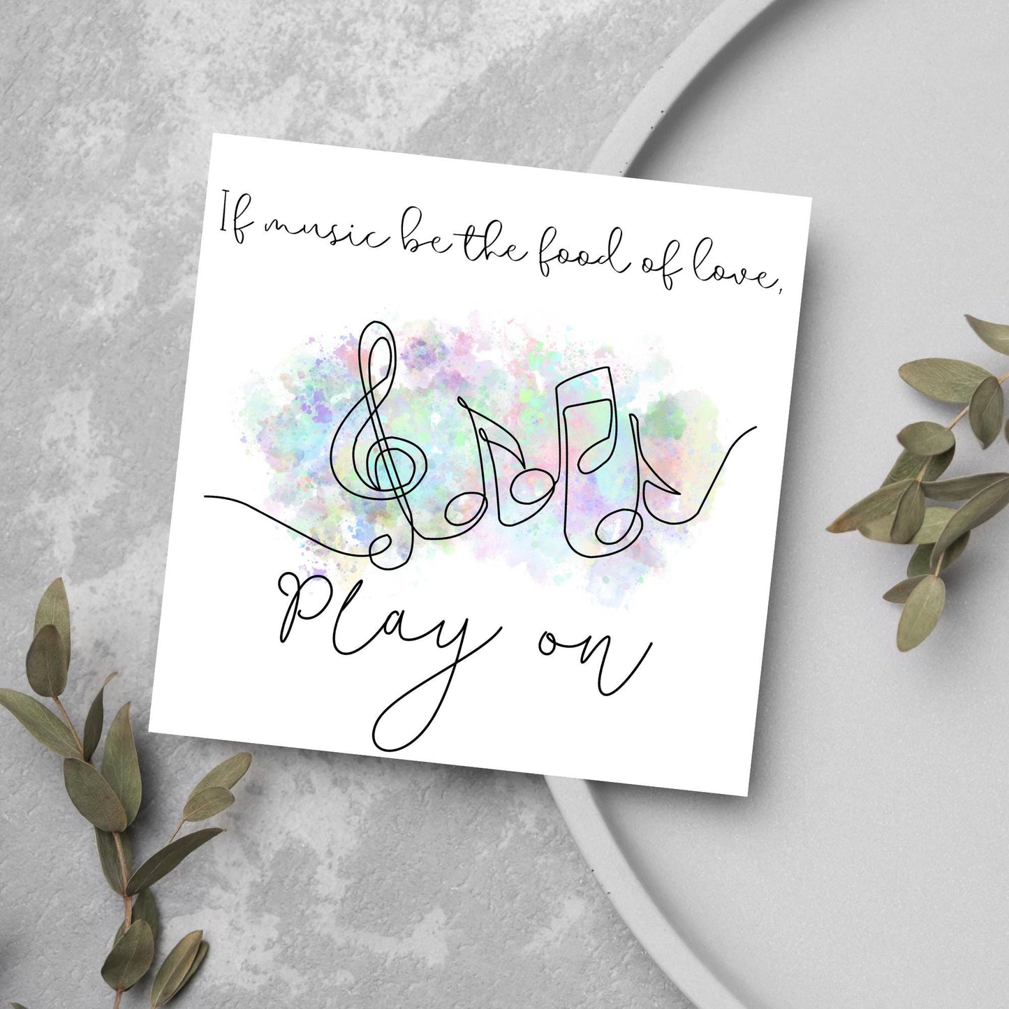 White square card with a one line drawing of musical notes that look like they are dancing in front of a pastel rainbow watercolour cloud. Cursive text reads, If music be the food of love, play on