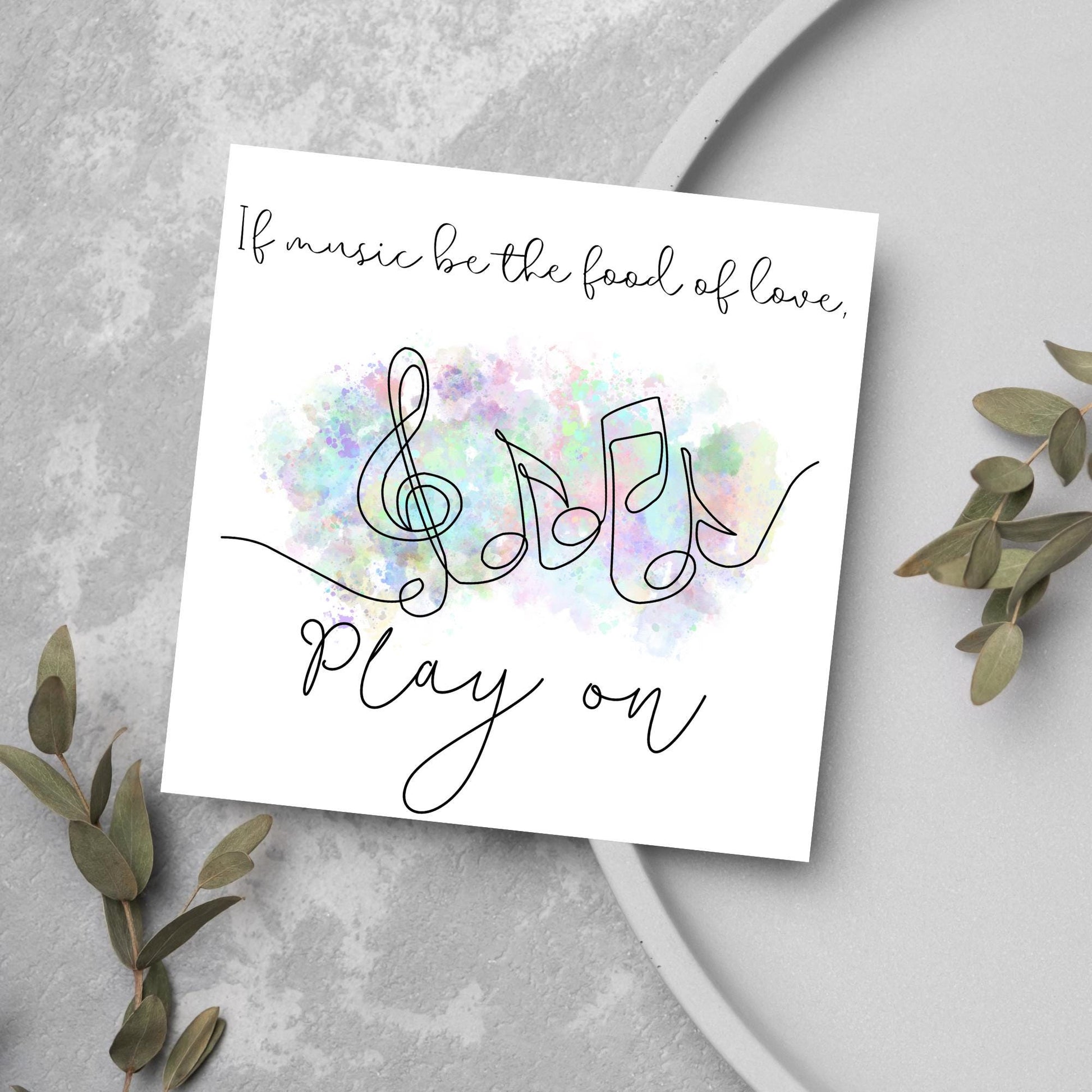 White square card with a one line drawing of musical notes that look like they are dancing in front of a pastel rainbow watercolour cloud. Cursive text reads, If music be the food of love, play on
