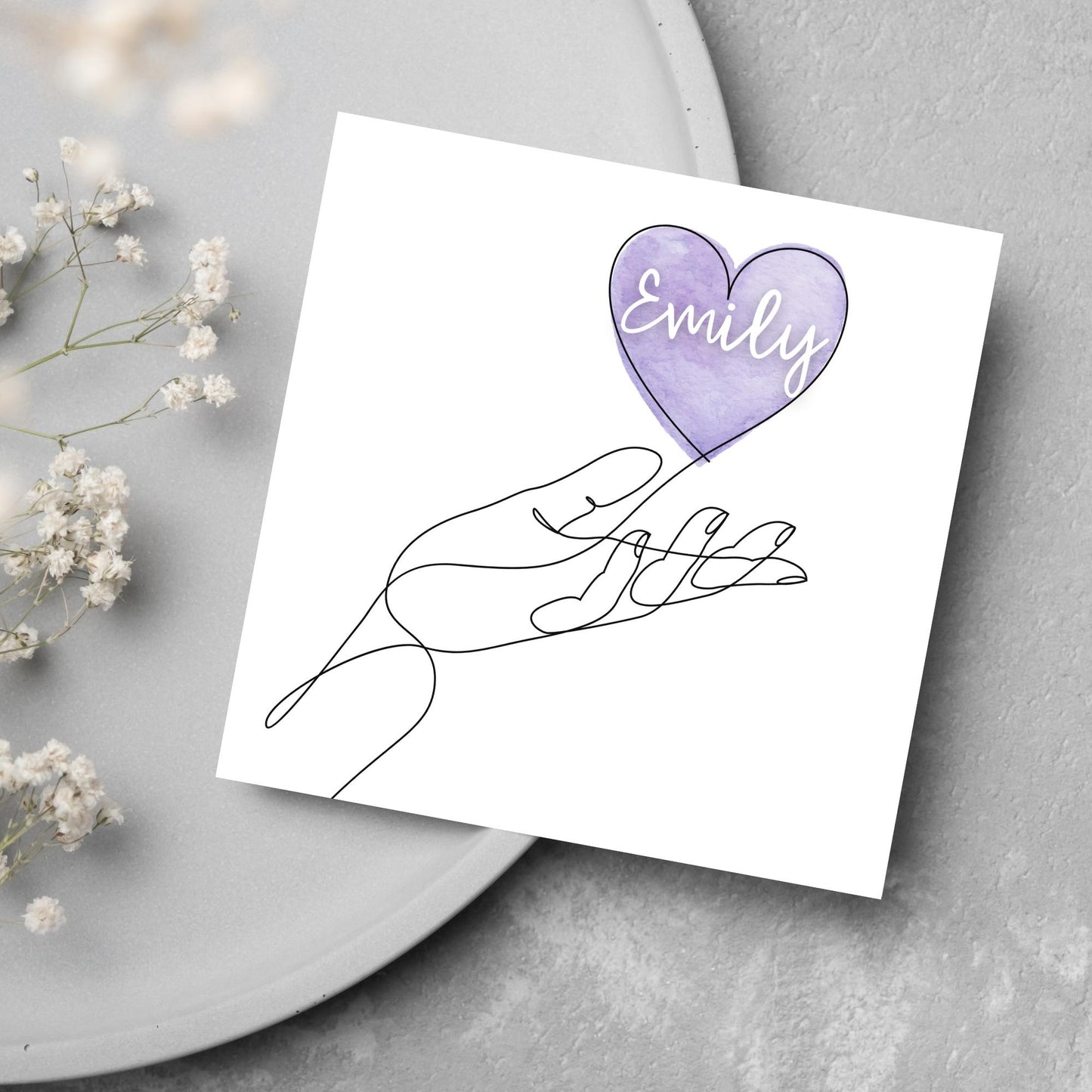 square card with a simple black and white one line drawing of an open hand with a heart rising from the hand. the heart has a purple background and has a personalised name written in a white cursive text