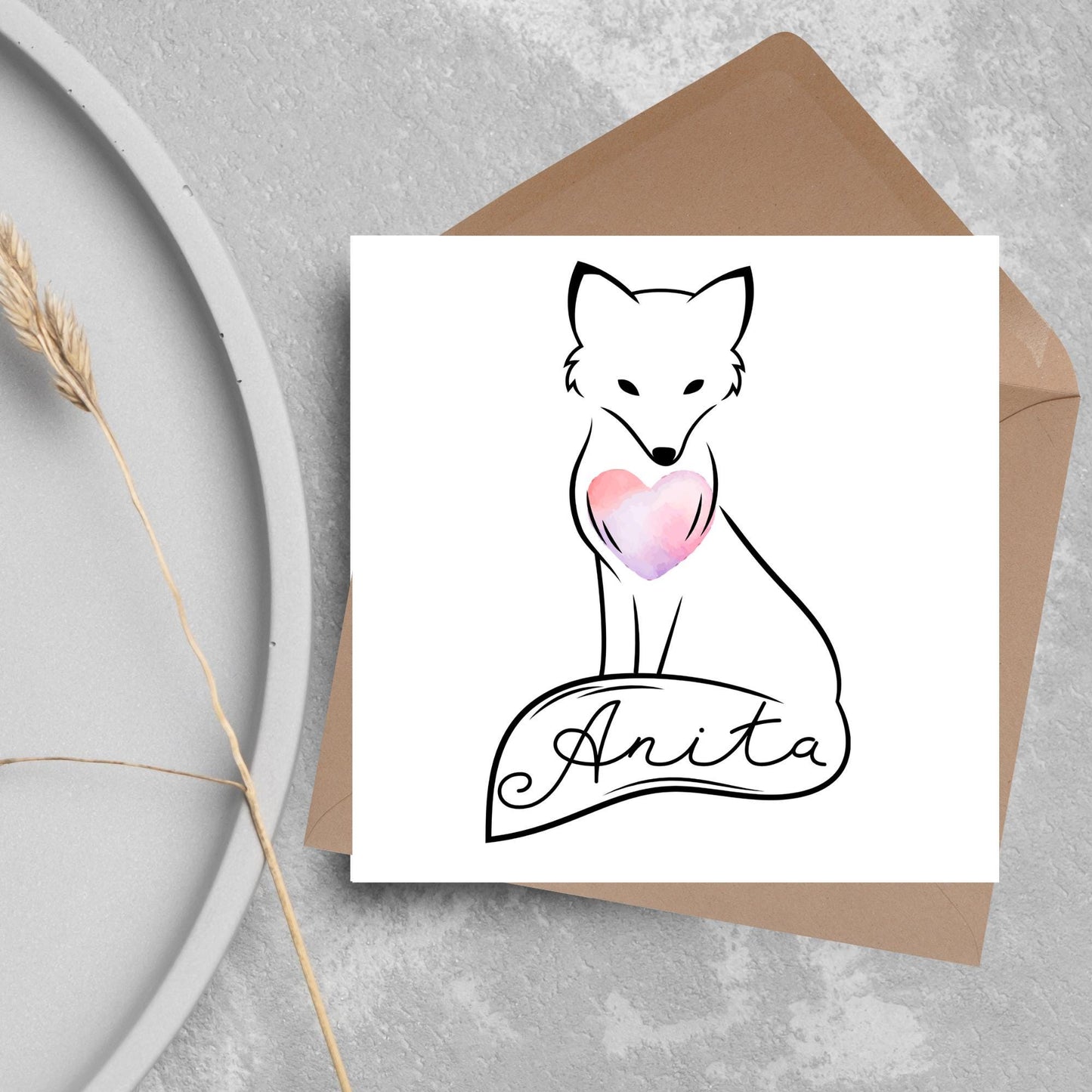 Square card with simple black line drawing of a fox sitting with its tail wrapped around its feet. It has a pink watercolour heart on its chest and personalised with a name on the tail in a calligraphy font