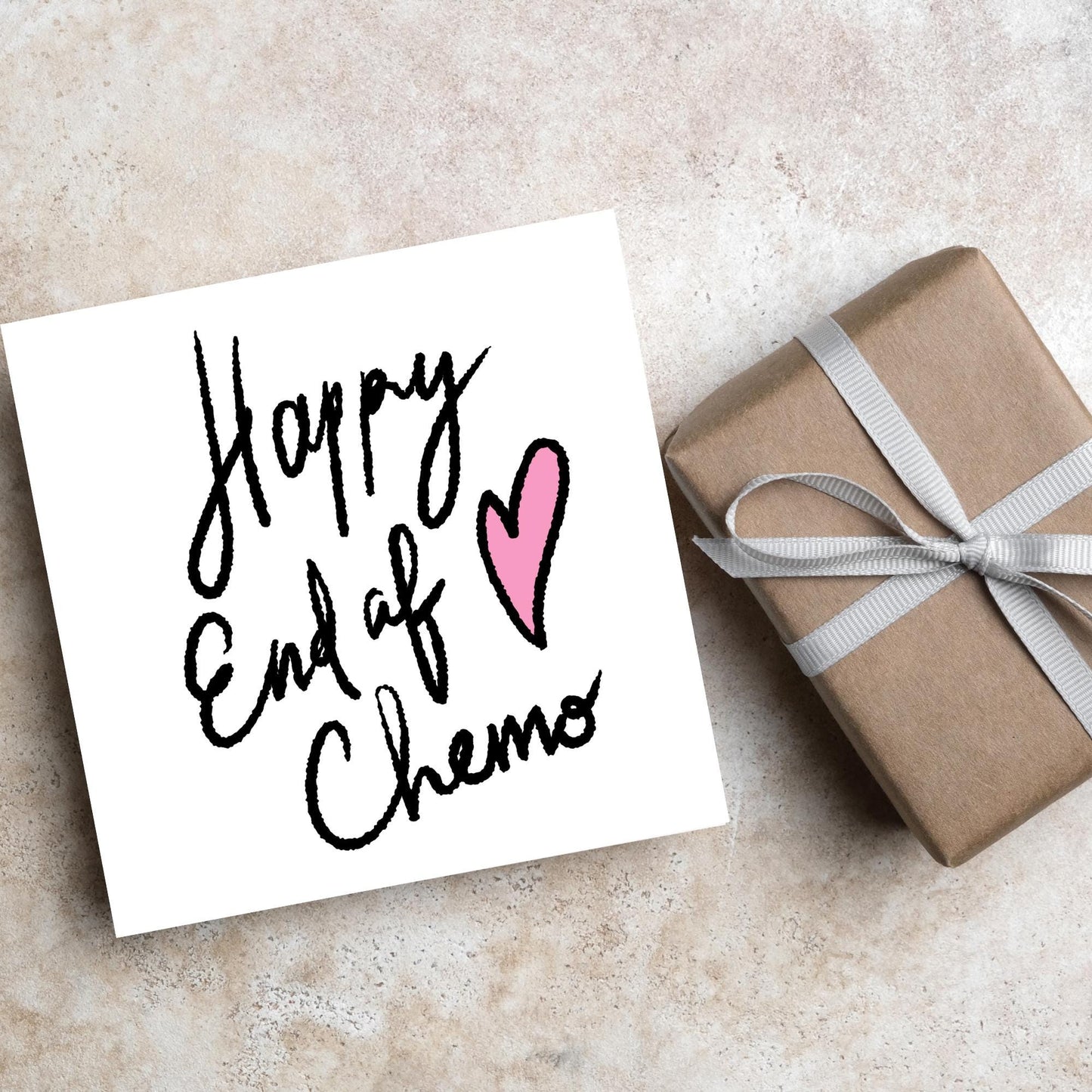 Simple square card with a white backdrop and black handwritten style text that reads HAPPY END OF CHEMO with a roughly drawn pink heart next to the text.