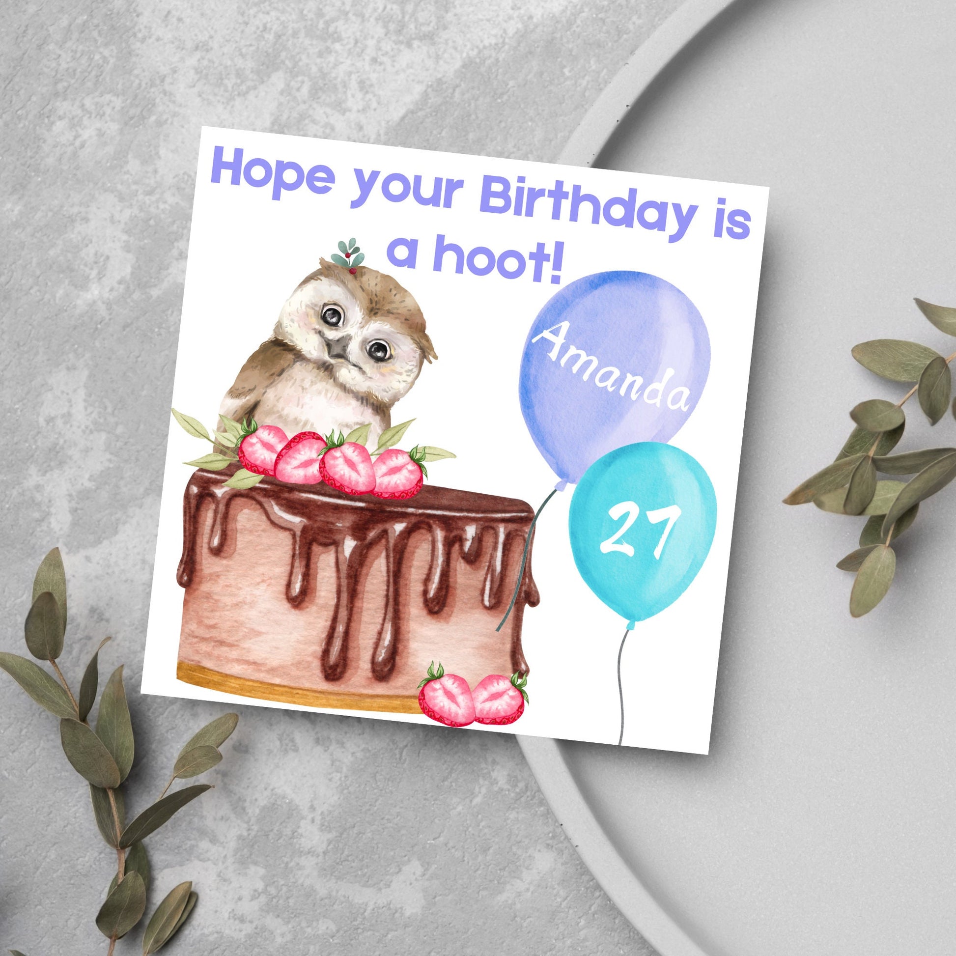 square birthday card with a cute owl sitting on a chocolate cake with the text hope our birthday is a hoot. next to the owl are two blue balloons, one with the name of the person and one with the age in white writing