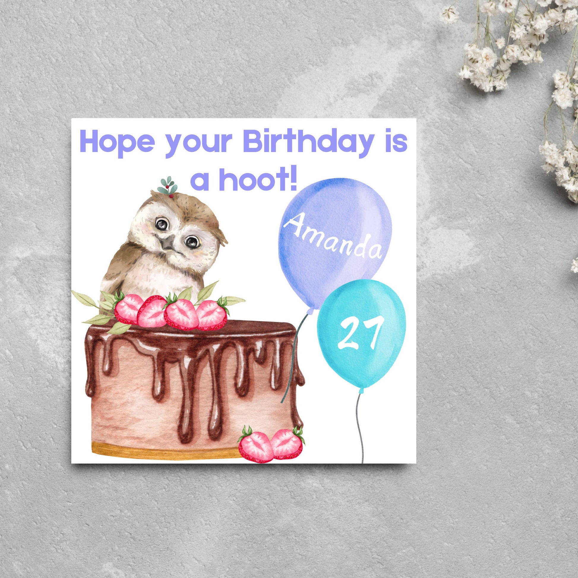 square birthday card with a cute owl sitting on a chocolate cake with the text hope our birthday is a hoot. next to the owl are two blue balloons, one with the name of the person and one with the age in white writing