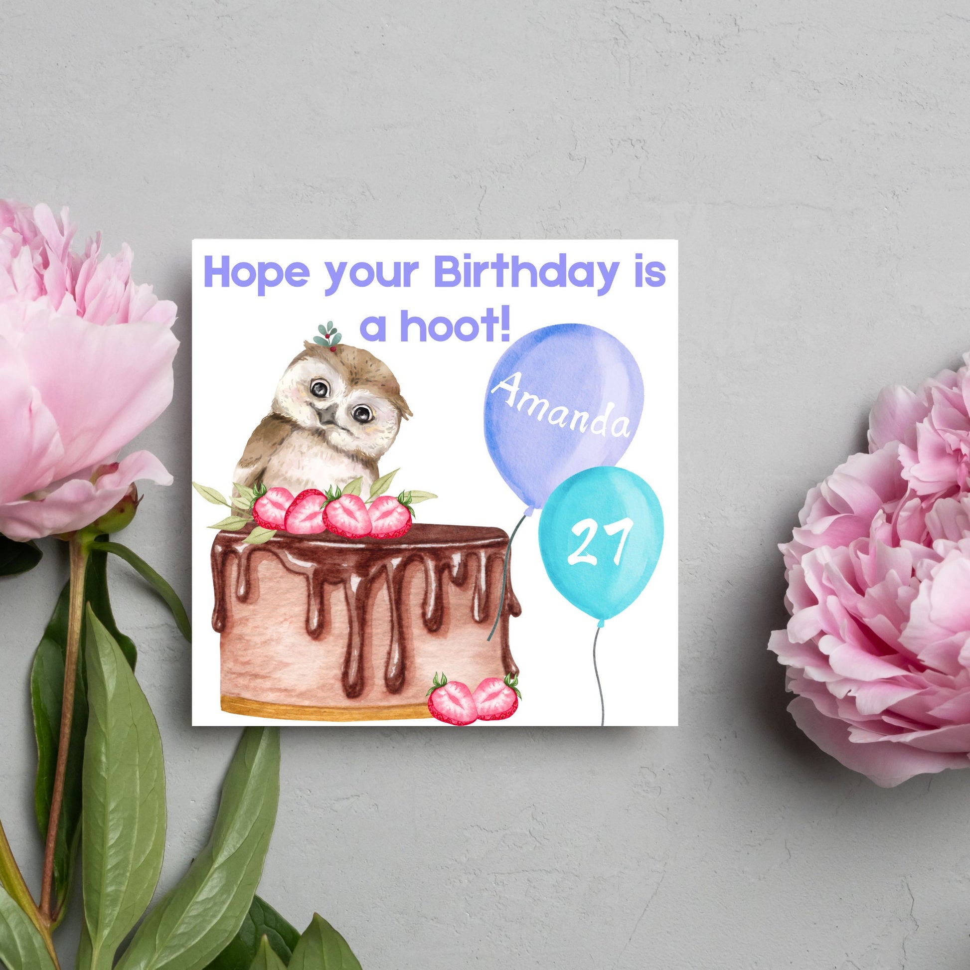 square birthday card with a cute owl sitting on a chocolate cake with the text hope our birthday is a hoot. next to the owl are two blue balloons, one with the name of the person and one with the age in white writing