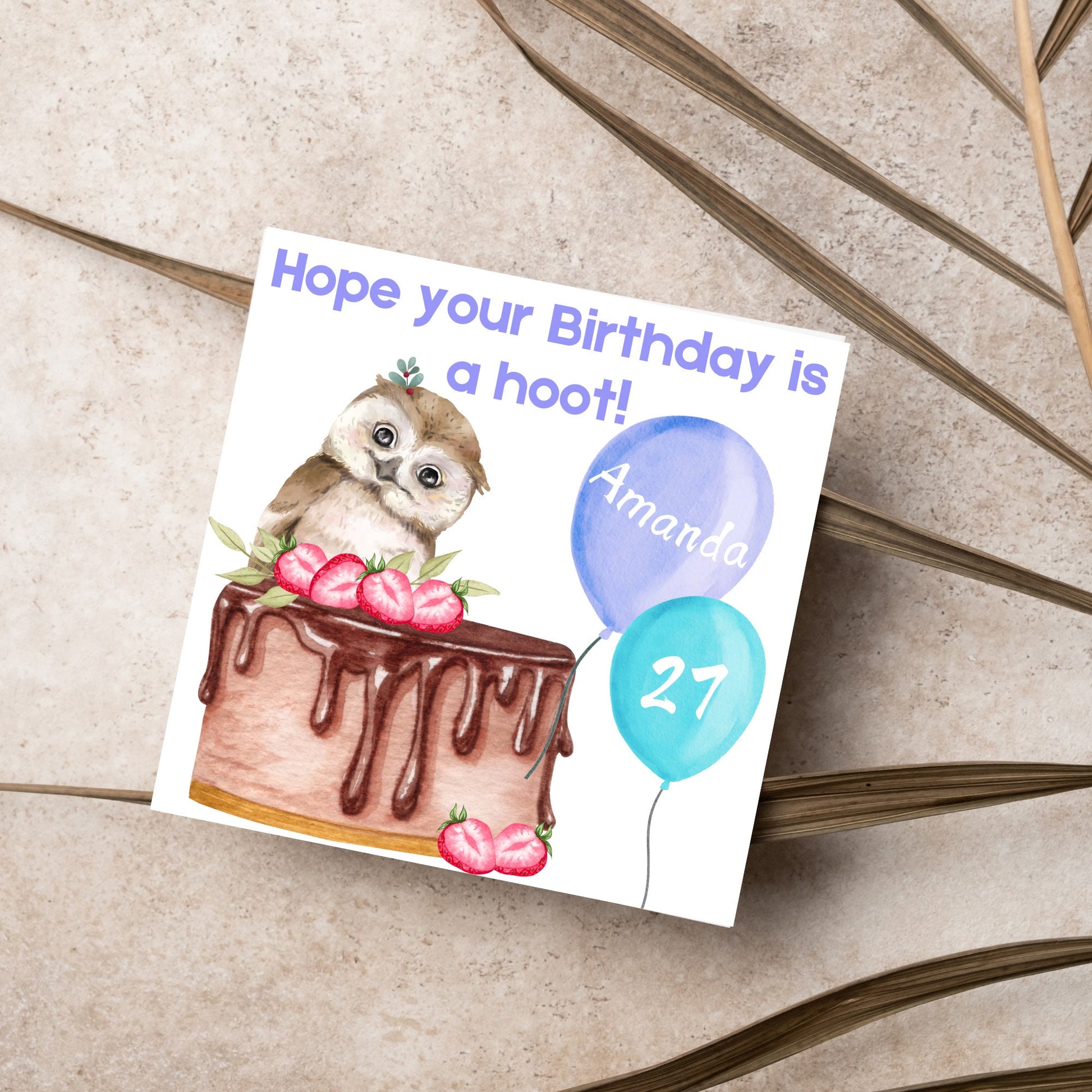 square birthday card with a cute owl sitting on a chocolate cake with the text hope our birthday is a hoot. next to the owl are two blue balloons, one with the name of the person and one with the age in white writing