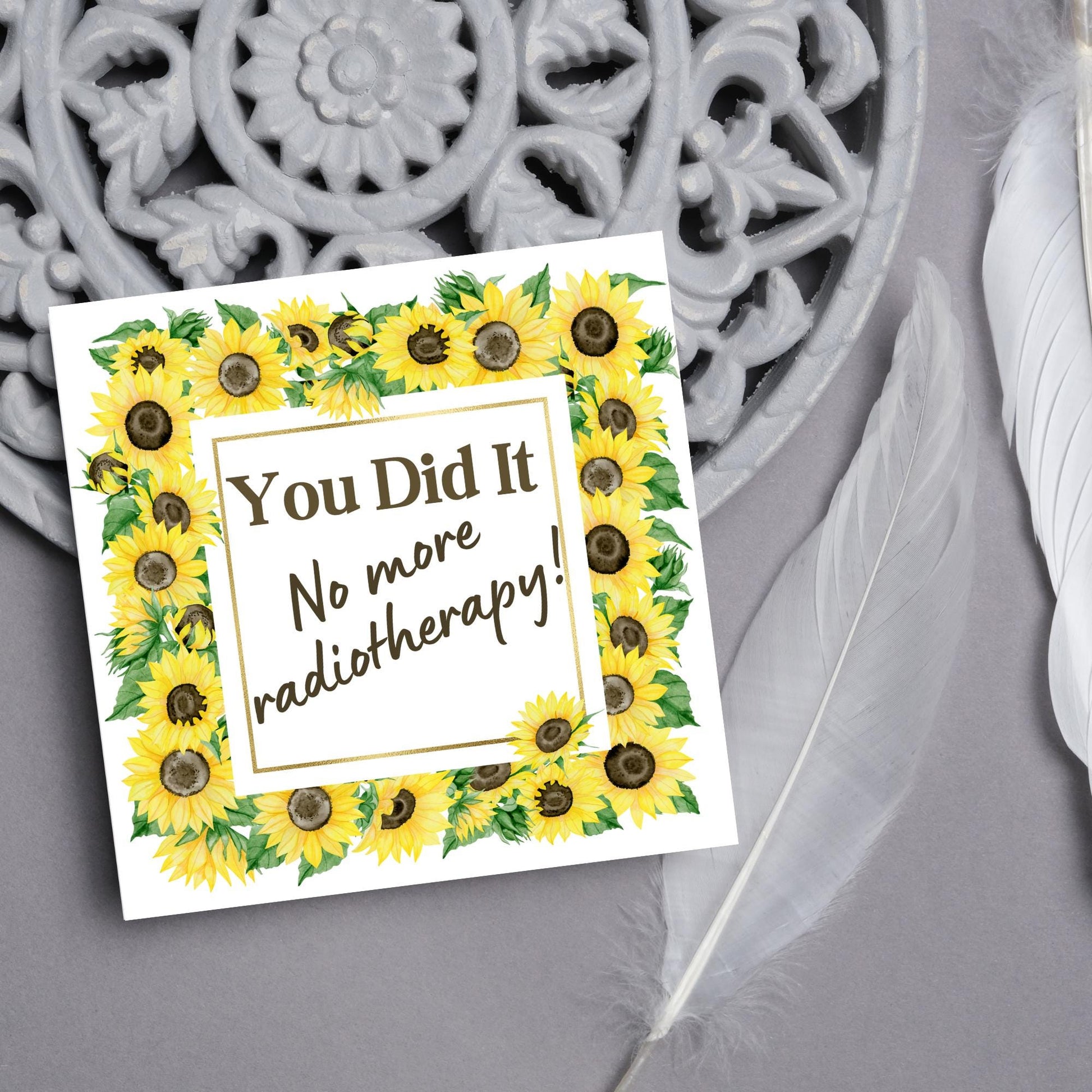 square greetings card with a watercolour border of sunflowers framing the text - You did it no more radiotherapy - in a subtle brown font
