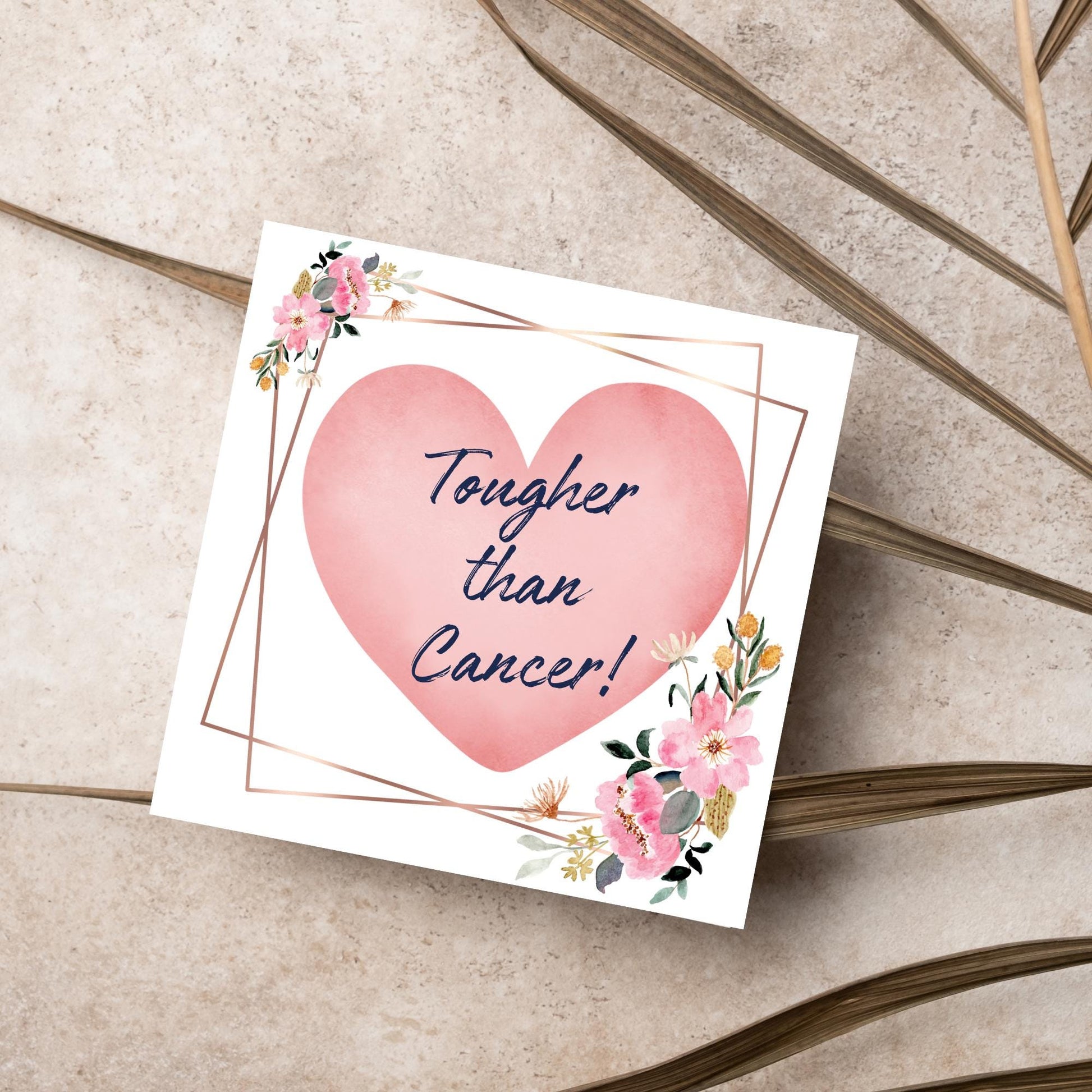 Square white card with a watercolour floral border frame and a pink heart in the centre with the text Tougher than cancer in s handwritten style navy blue font