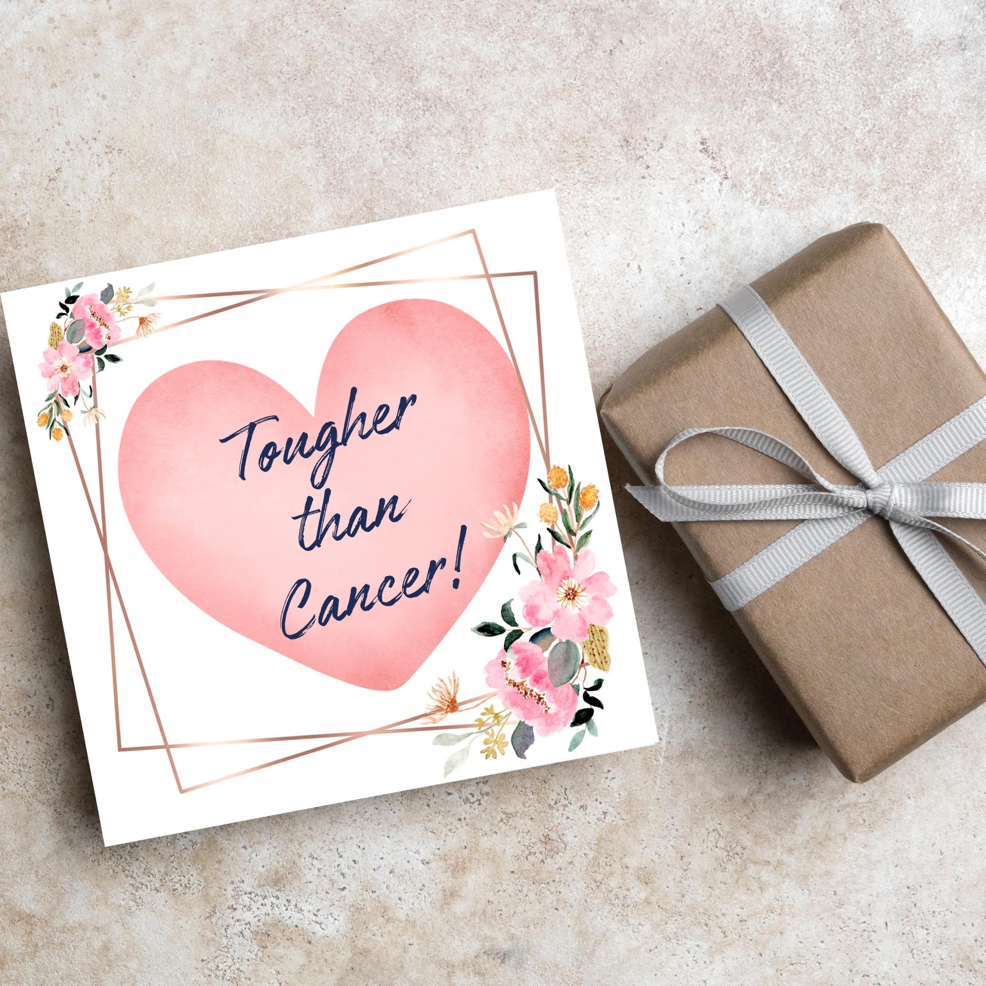 Square white card with a watercolour floral border frame and a pink heart in the centre with the text Tougher than cancer in s handwritten style navy blue font