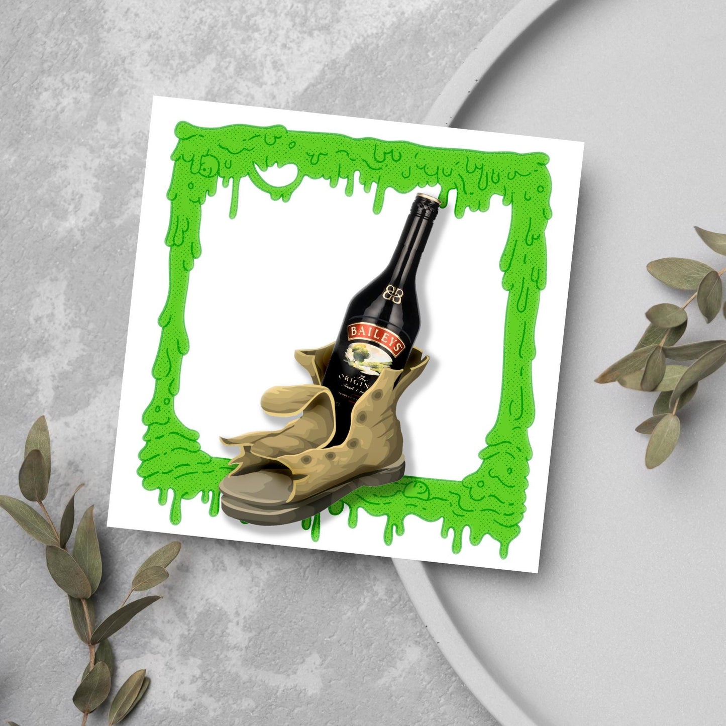 image of a square greetings card with a green slime frame with an image of an old boot with a bottle of baileys inside it