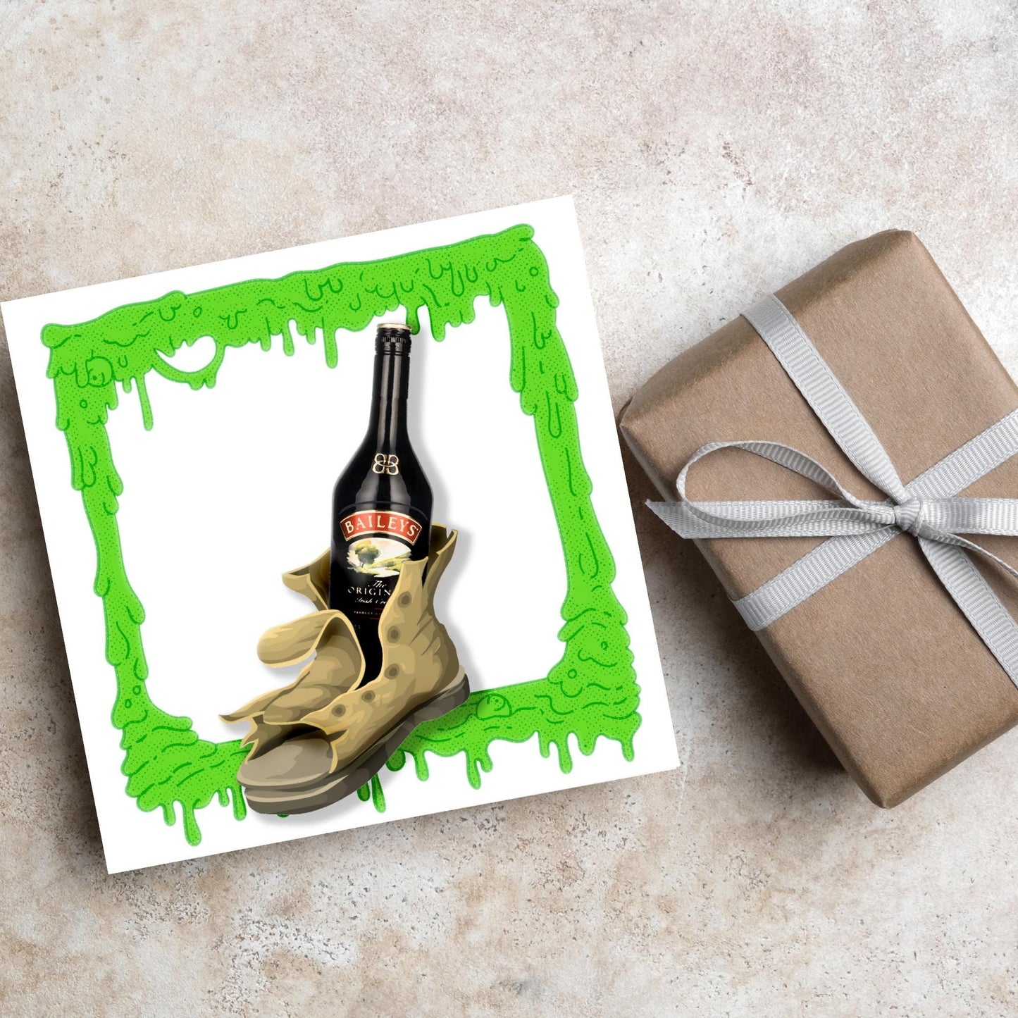 image of a square greetings card with a green slime frame with an image of an old boot with a bottle of baileys inside it