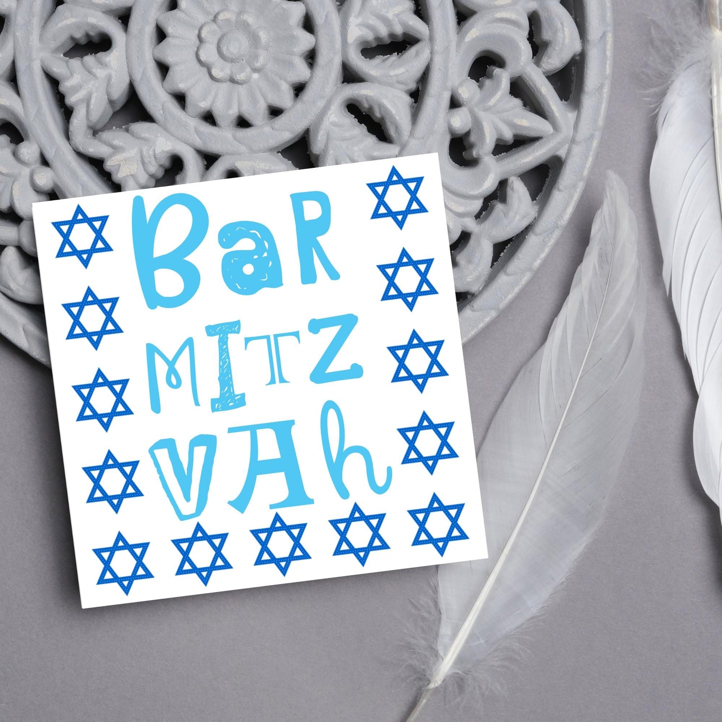 square greeting card for bar mitzvah with blue text bar mitzvah in a hand drawn style made of different fonts surrounded by 13 stars of David in navy blue