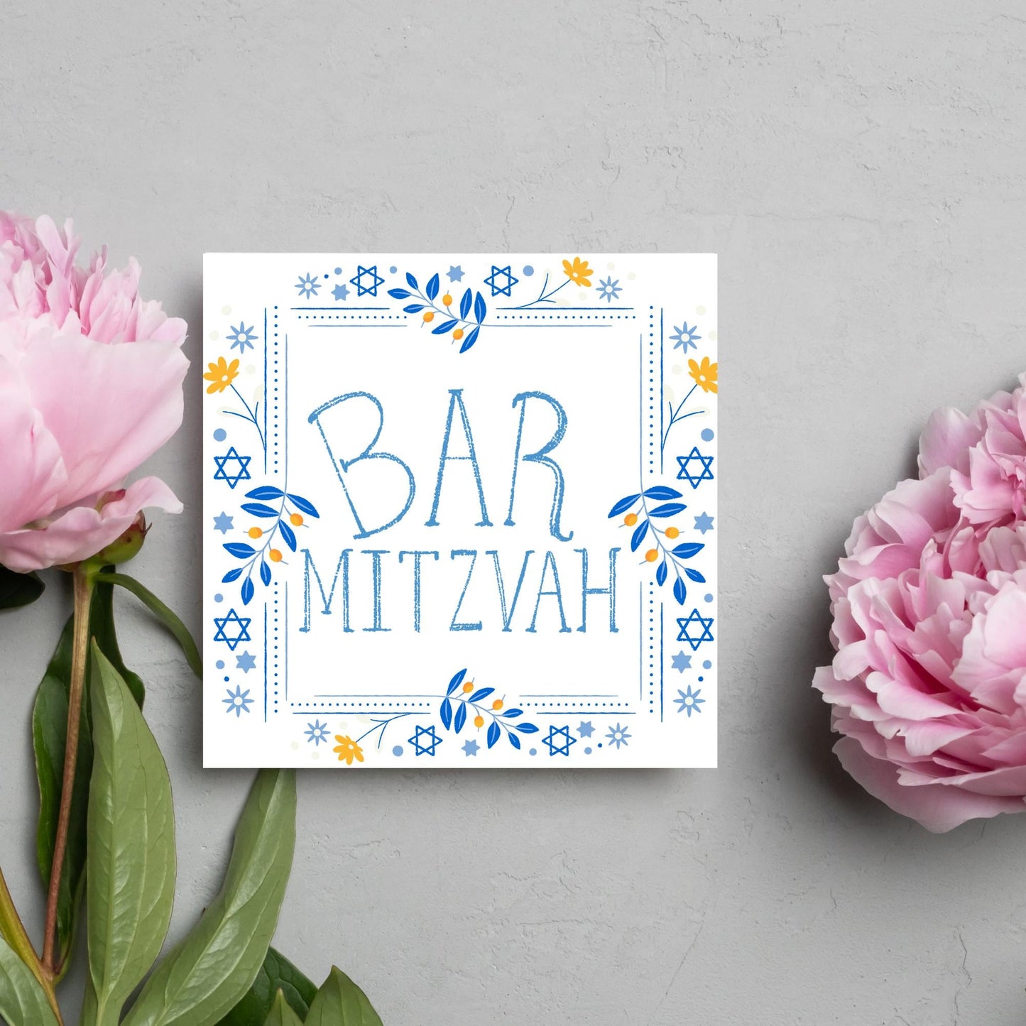 square bar mitzvah card with a sketchy drawn bar mitzvah in the centre in a soft blue, with a decorative frame featuring flowers and stars of david in blues and yellows