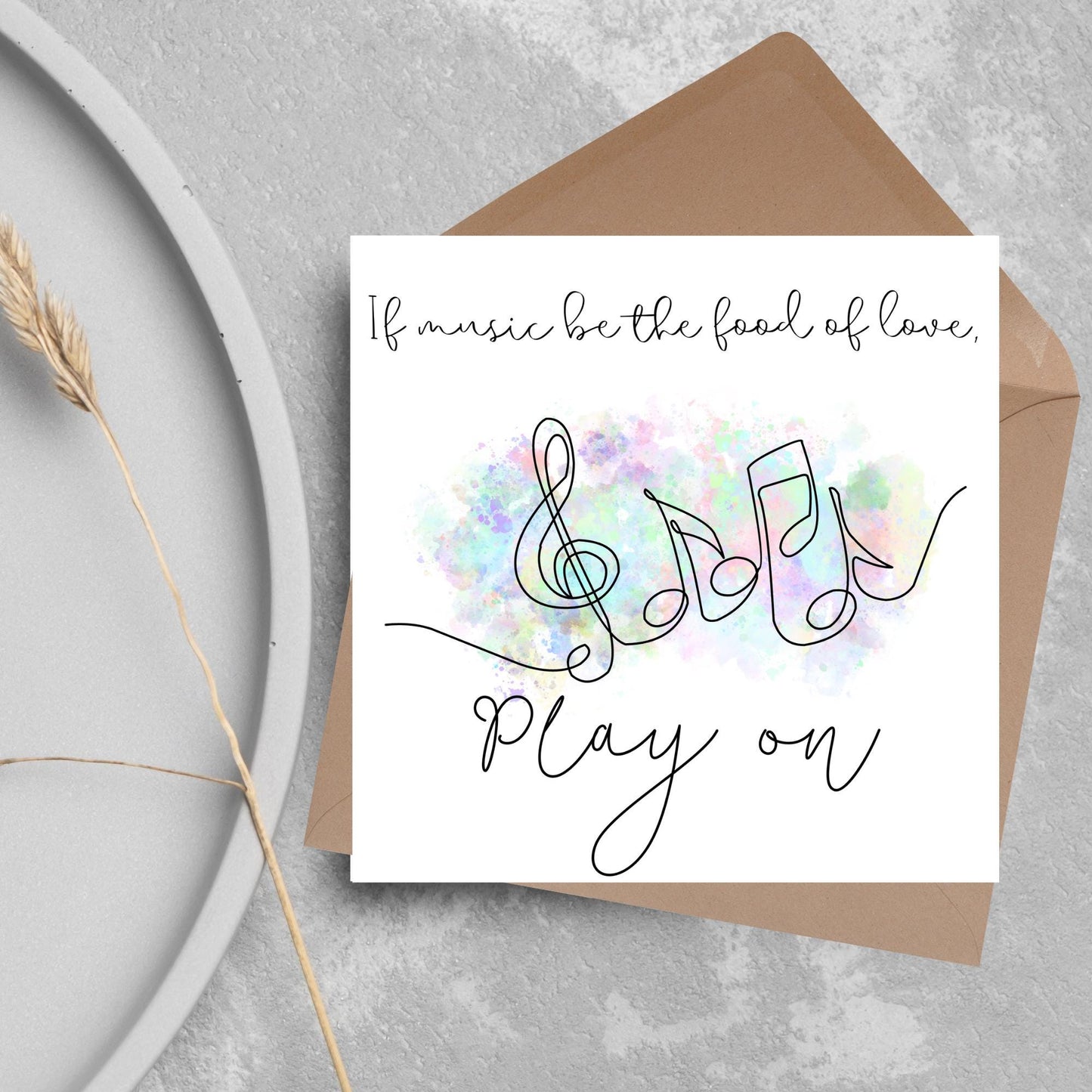 White square card with a one line drawing of musical notes that look like they are dancing in front of a pastel rainbow watercolour cloud. Cursive text reads, If music be the food of love, play on