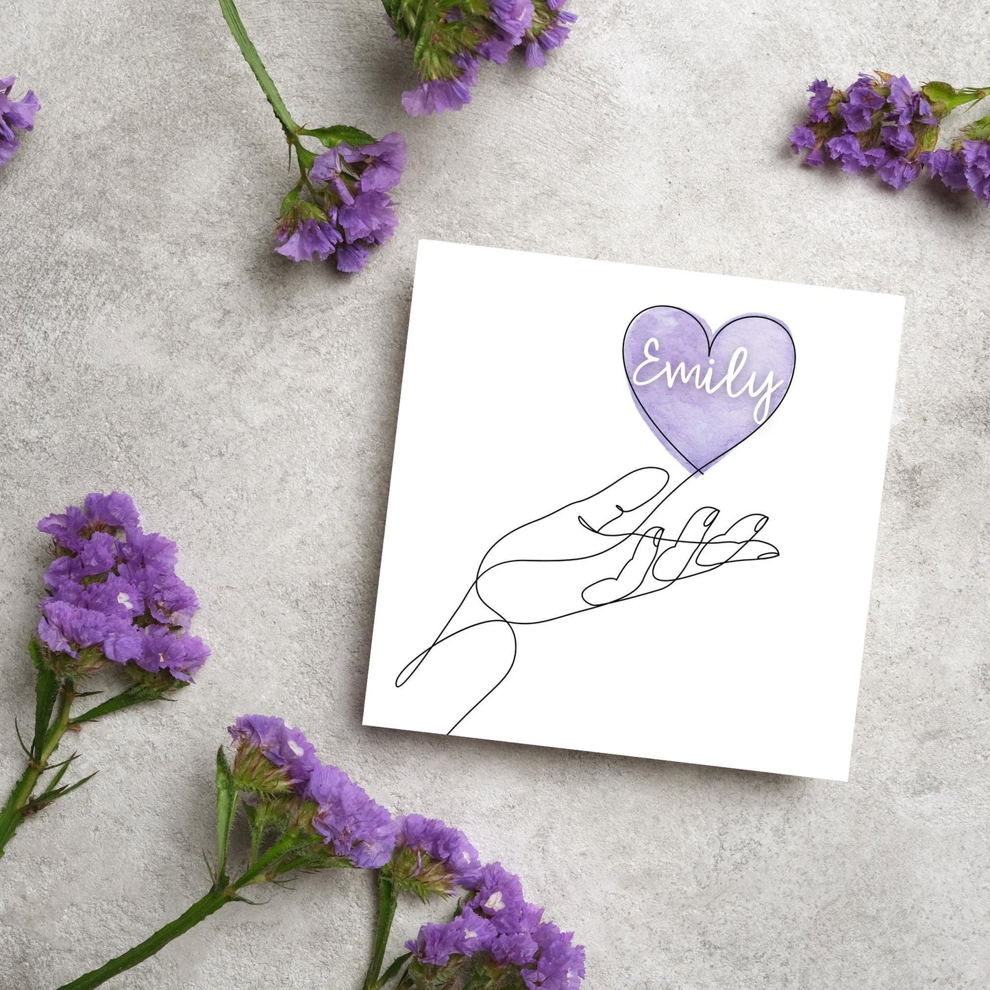 square card with a simple black and white one line drawing of an open hand with a heart rising from the hand. the heart has a purple background and has a personalised name written in a white cursive text