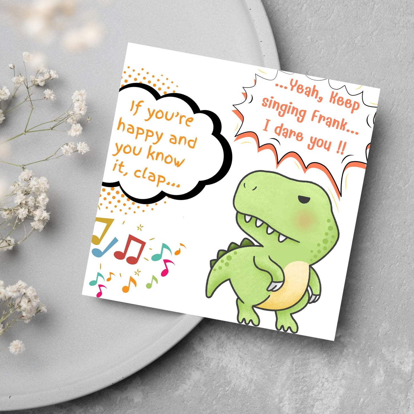 A cute, grumpy green T-Rex with tiny arms is featured. Text reads, "If you're happy and you know it, clap..." The T-Rex responds, "...Yeah, keep singing Frank... I dare you!!" Musical notes add a playful touch.