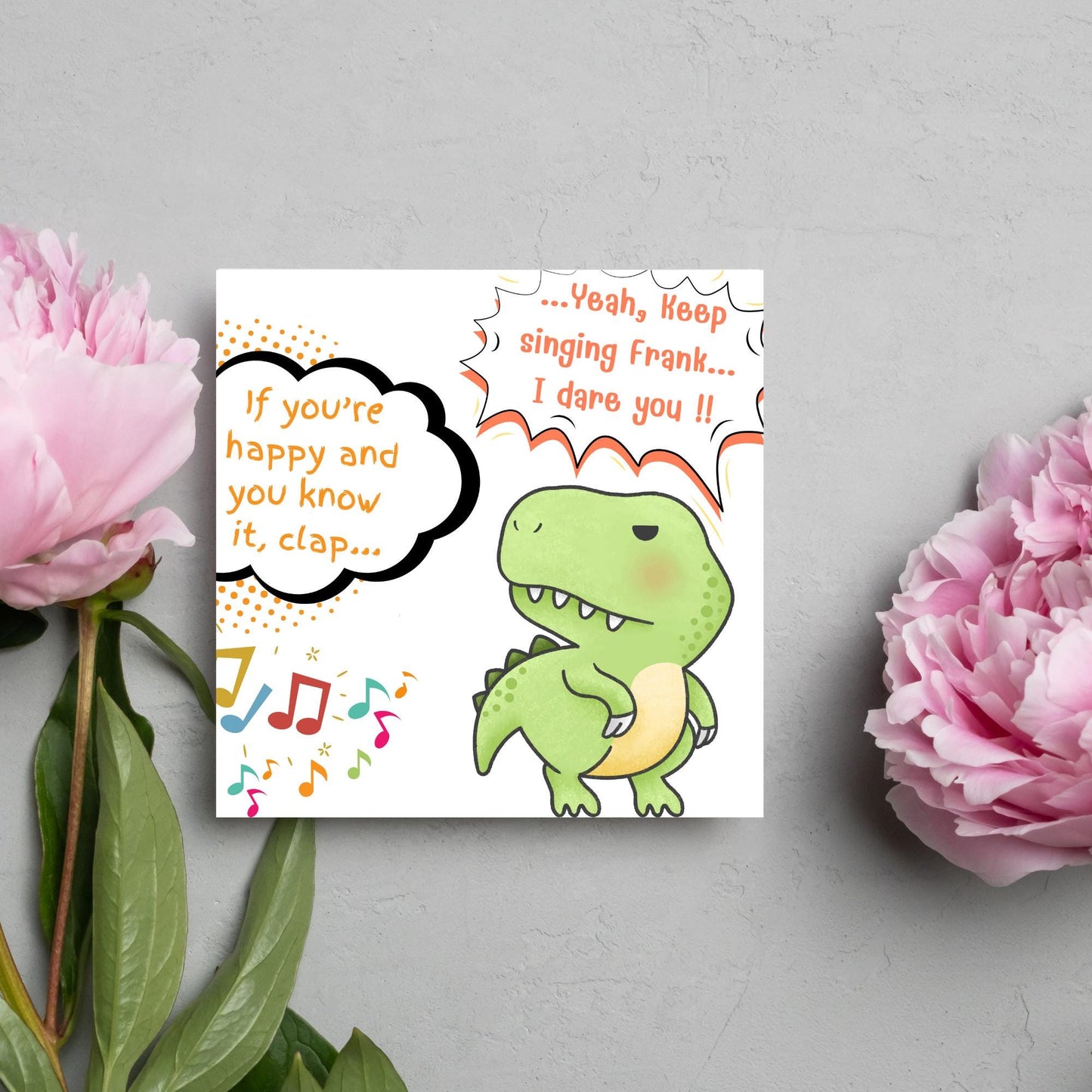 A cute, grumpy green T-Rex with tiny arms is featured. Text reads, "If you're happy and you know it, clap..." The T-Rex responds, "...Yeah, keep singing Frank... I dare you!!" Musical notes add a playful touch.