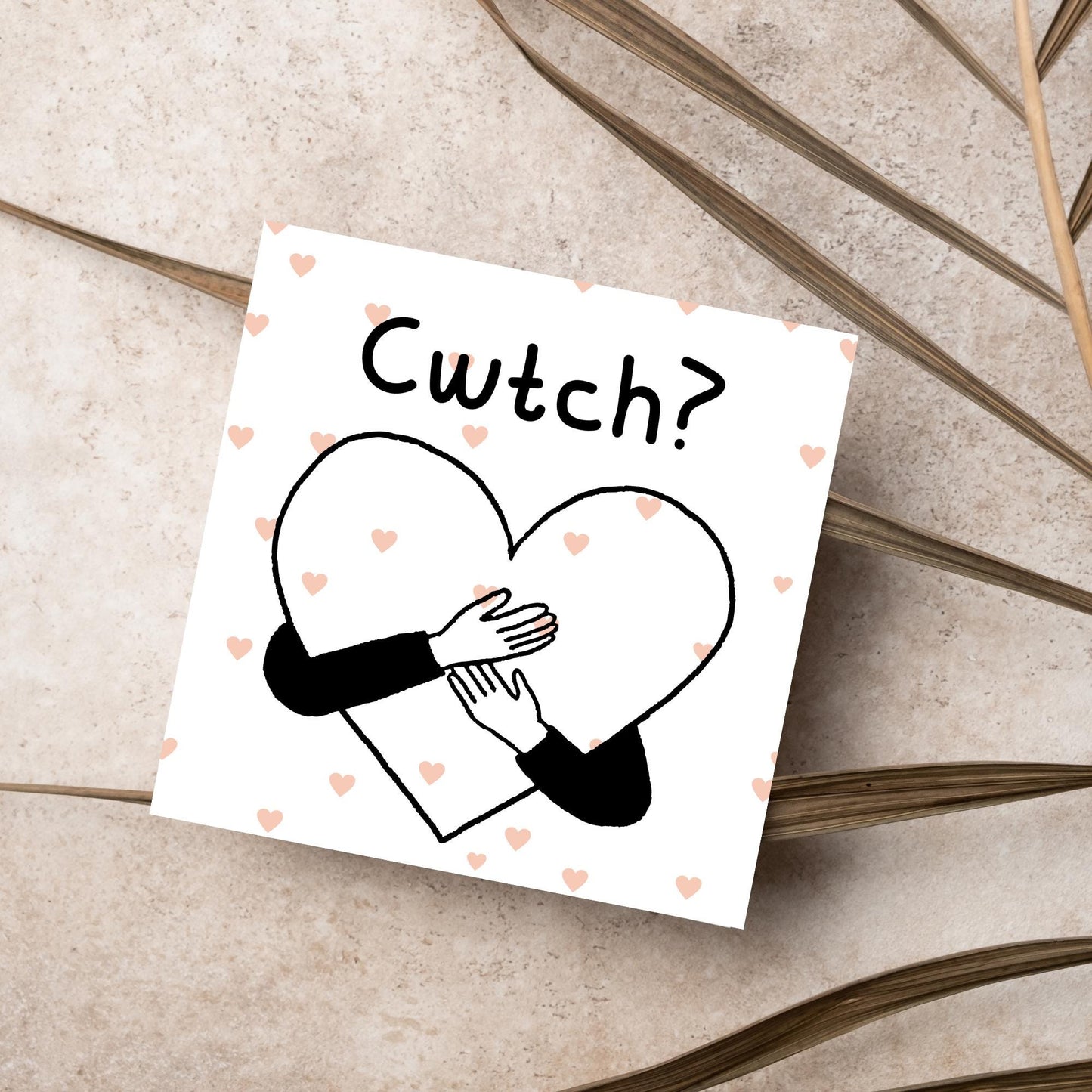 Square Greeting card small with subtle pink hearts in the background of a line drawn heart with hands hugging it and the word CWTCH? above it in handwritten style text