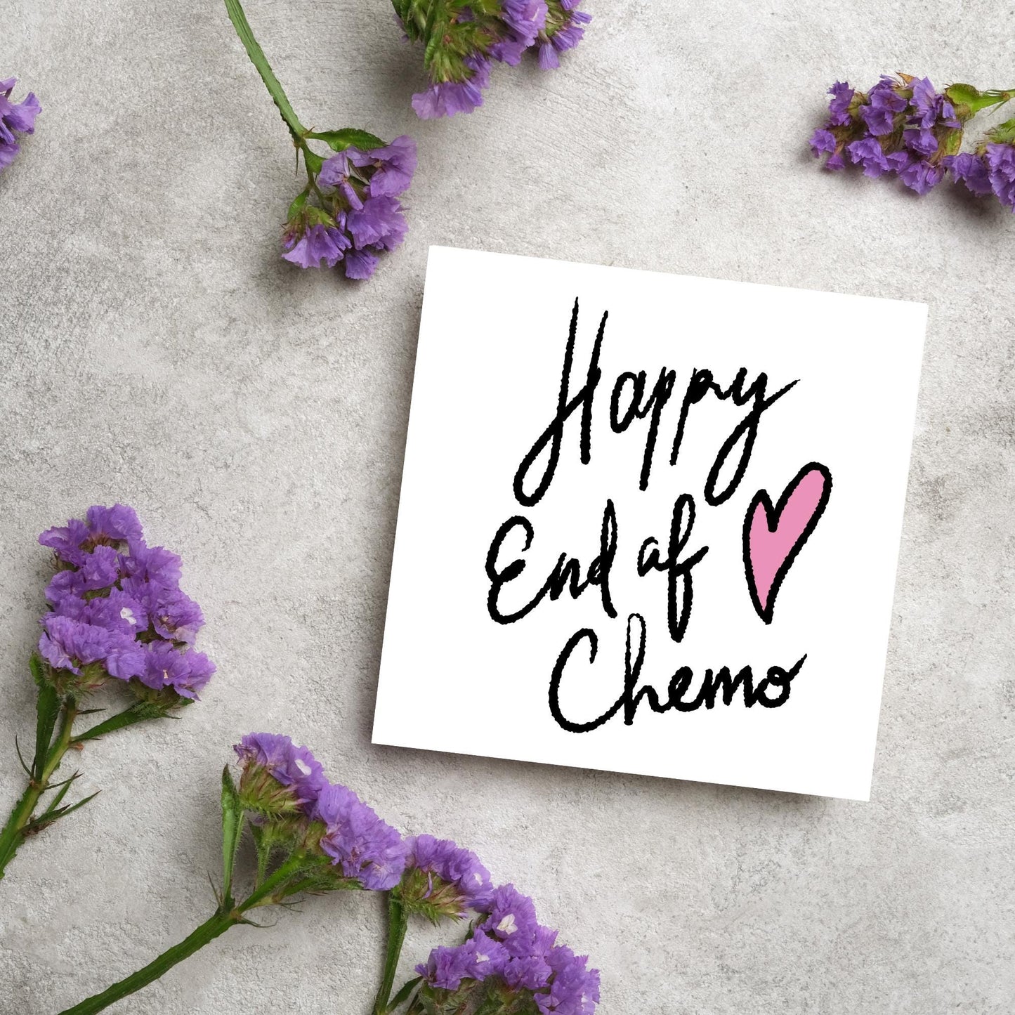 Simple square card with a white backdrop and black handwritten style text that reads HAPPY END OF CHEMO with a roughly drawn pink heart next to the text.
