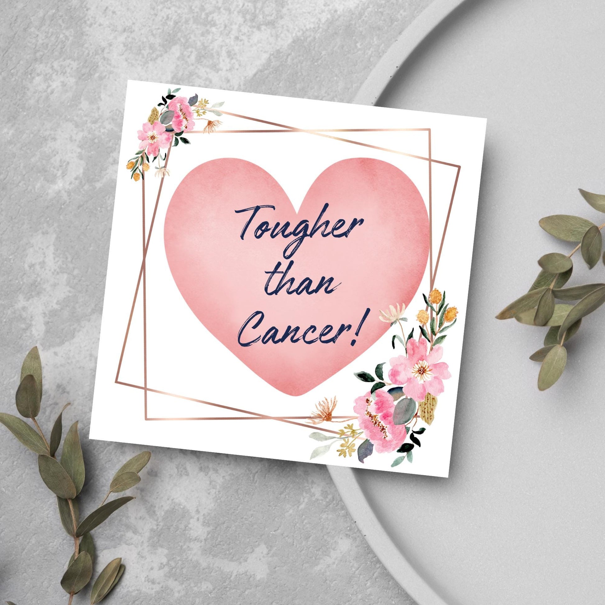 Square white card with a watercolour floral border frame and a pink heart in the centre with the text Tougher than cancer in s handwritten style navy blue font