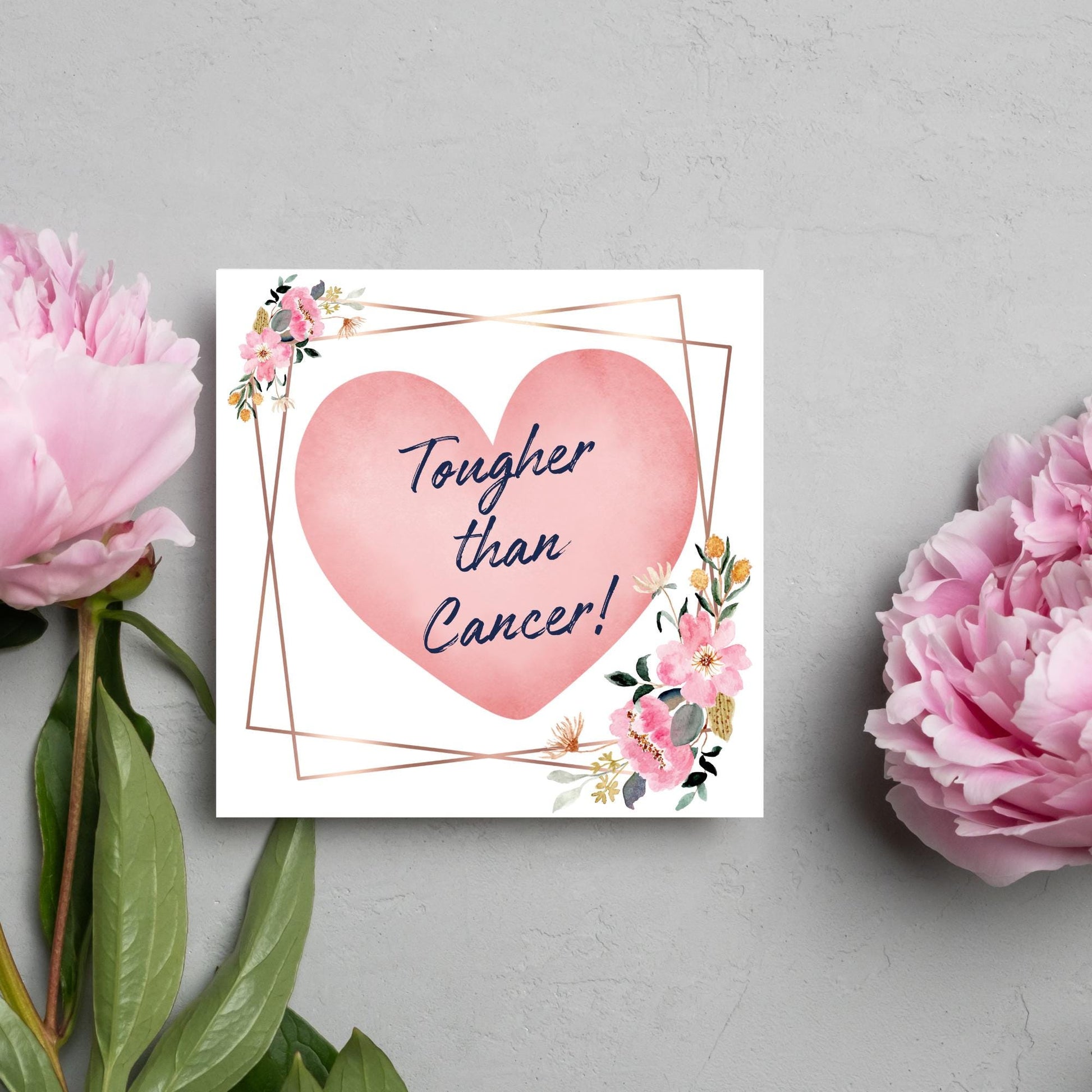 Square white card with a watercolour floral border frame and a pink heart in the centre with the text Tougher than cancer in s handwritten style navy blue font