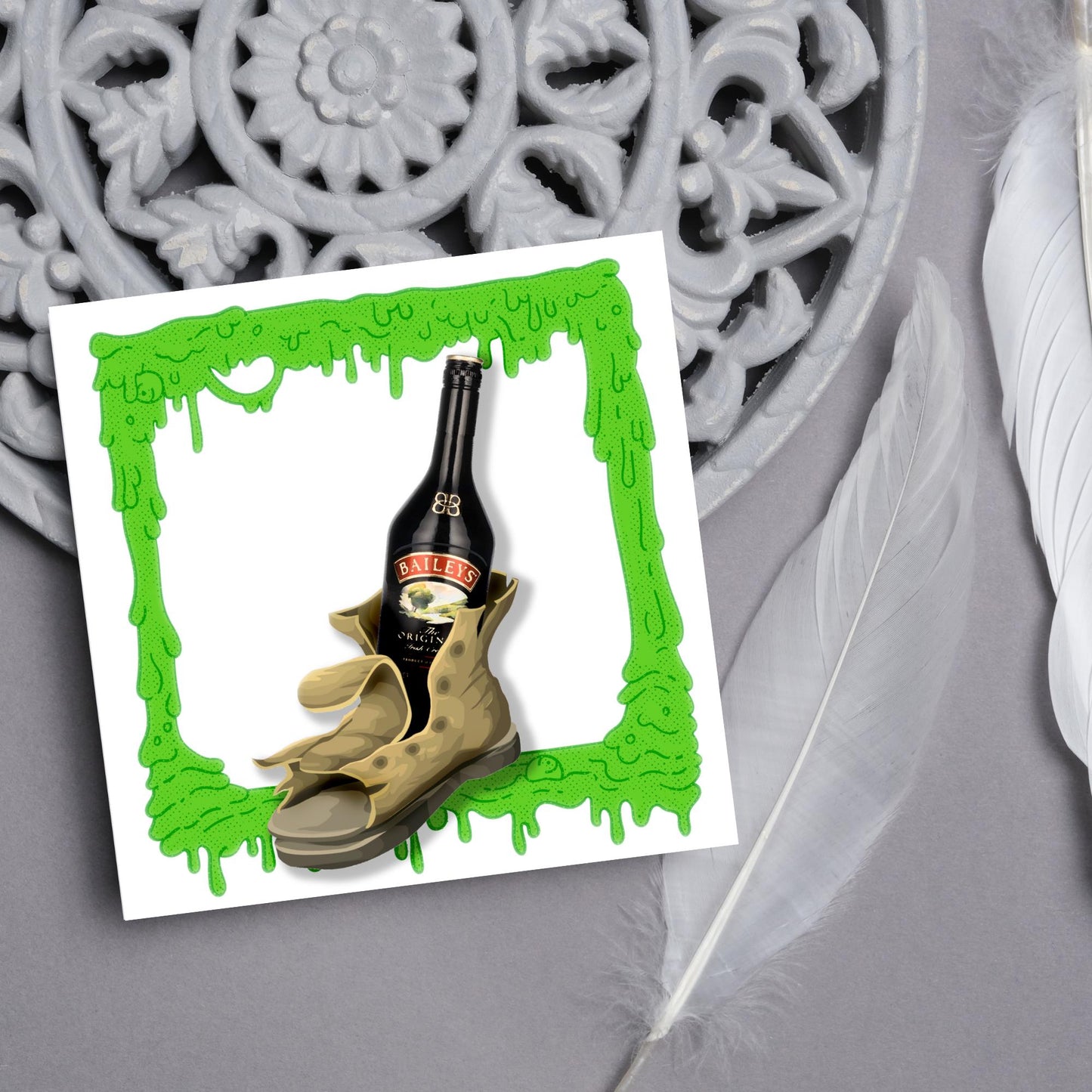 image of a square greetings card with a green slime frame with an image of an old boot with a bottle of baileys inside it