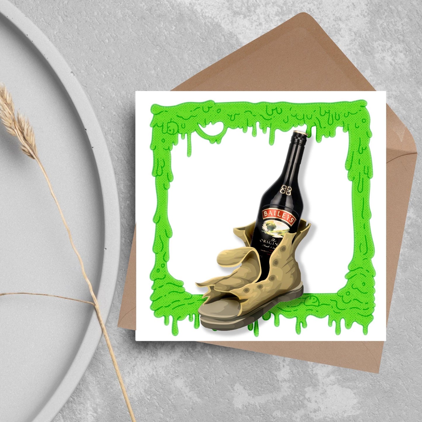 image of a square greetings card with a green slime frame with an image of an old boot with a bottle of baileys inside it
