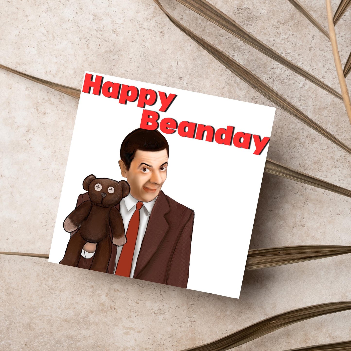 square card with a hand drawn image of Mr bean holding his teddy pooky with a cheeky smile on his face with the words Happy Beanday above in bold red text