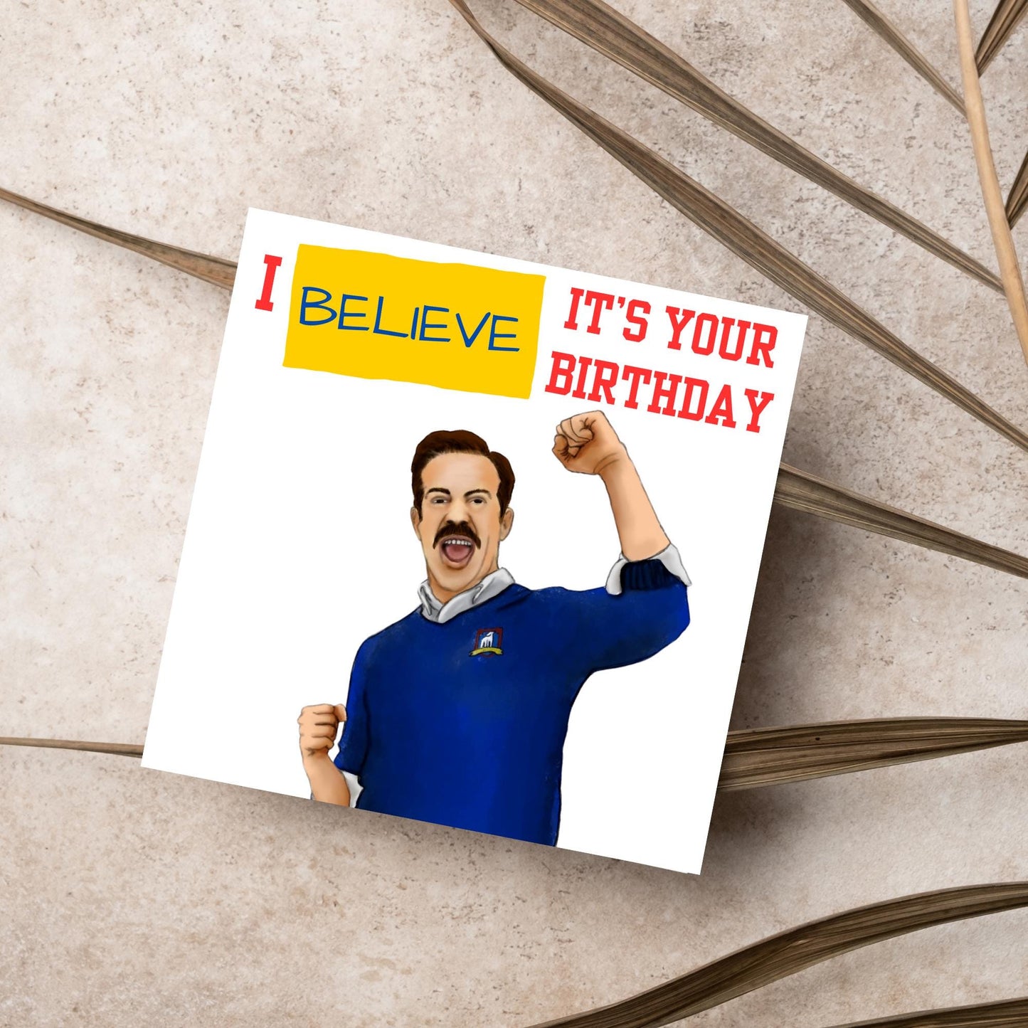 square greetings card with a hand drawn image of Jason Sudeikis character Ted Lasso giving a fist pump with the text - I believe it's your birthday