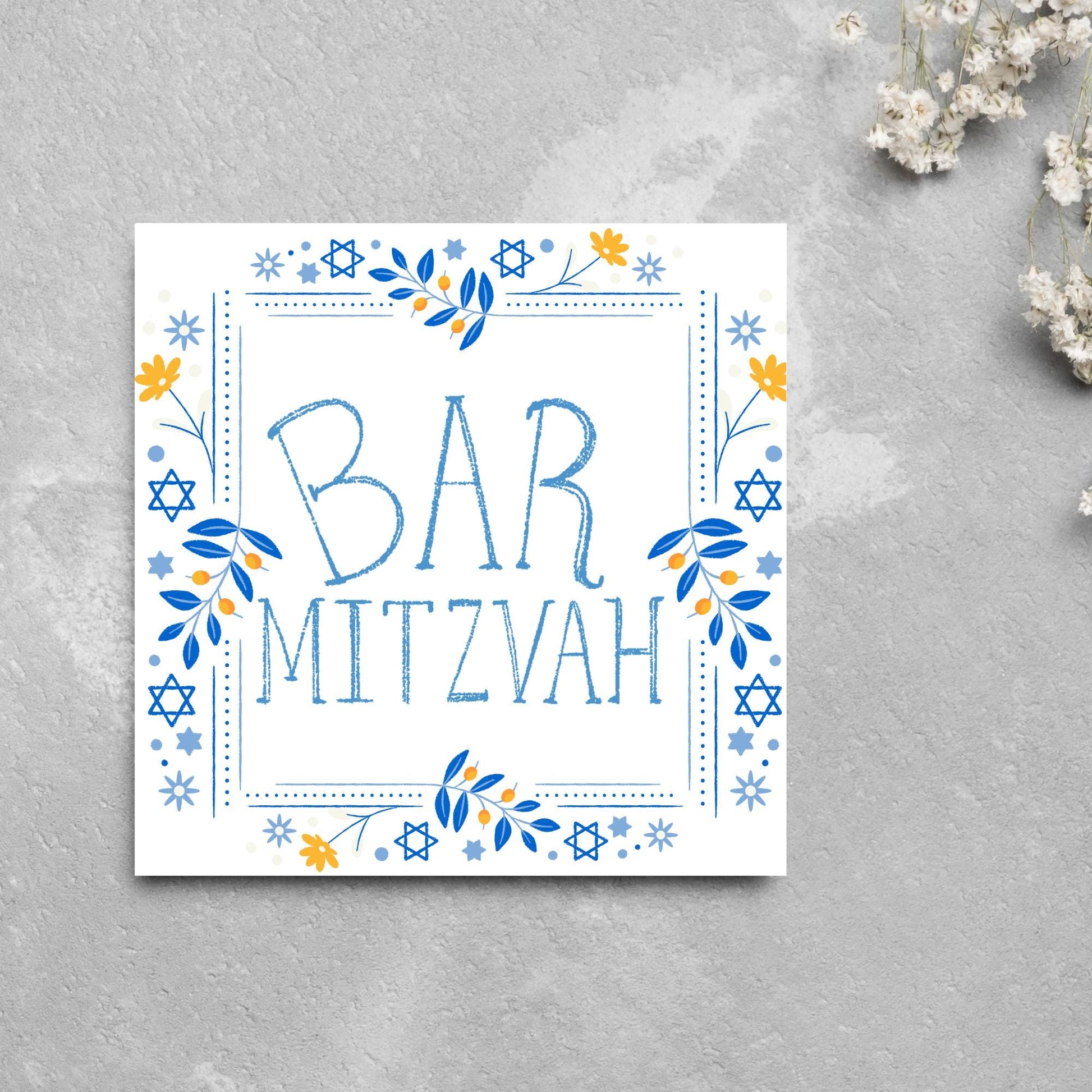 square bar mitzvah card with a sketchy drawn bar mitzvah in the centre in a soft blue, with a decorative frame featuring flowers and stars of david in blues and yellows