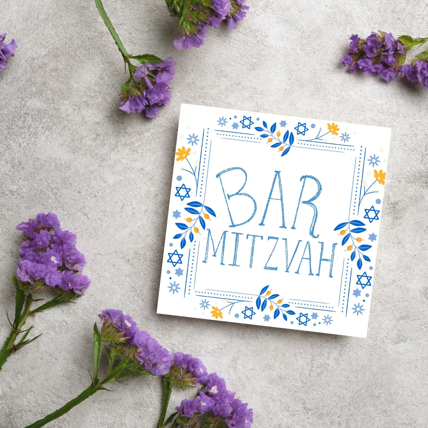 square bar mitzvah card with a sketchy drawn bar mitzvah in the centre in a soft blue, with a decorative frame featuring flowers and stars of david in blues and yellows