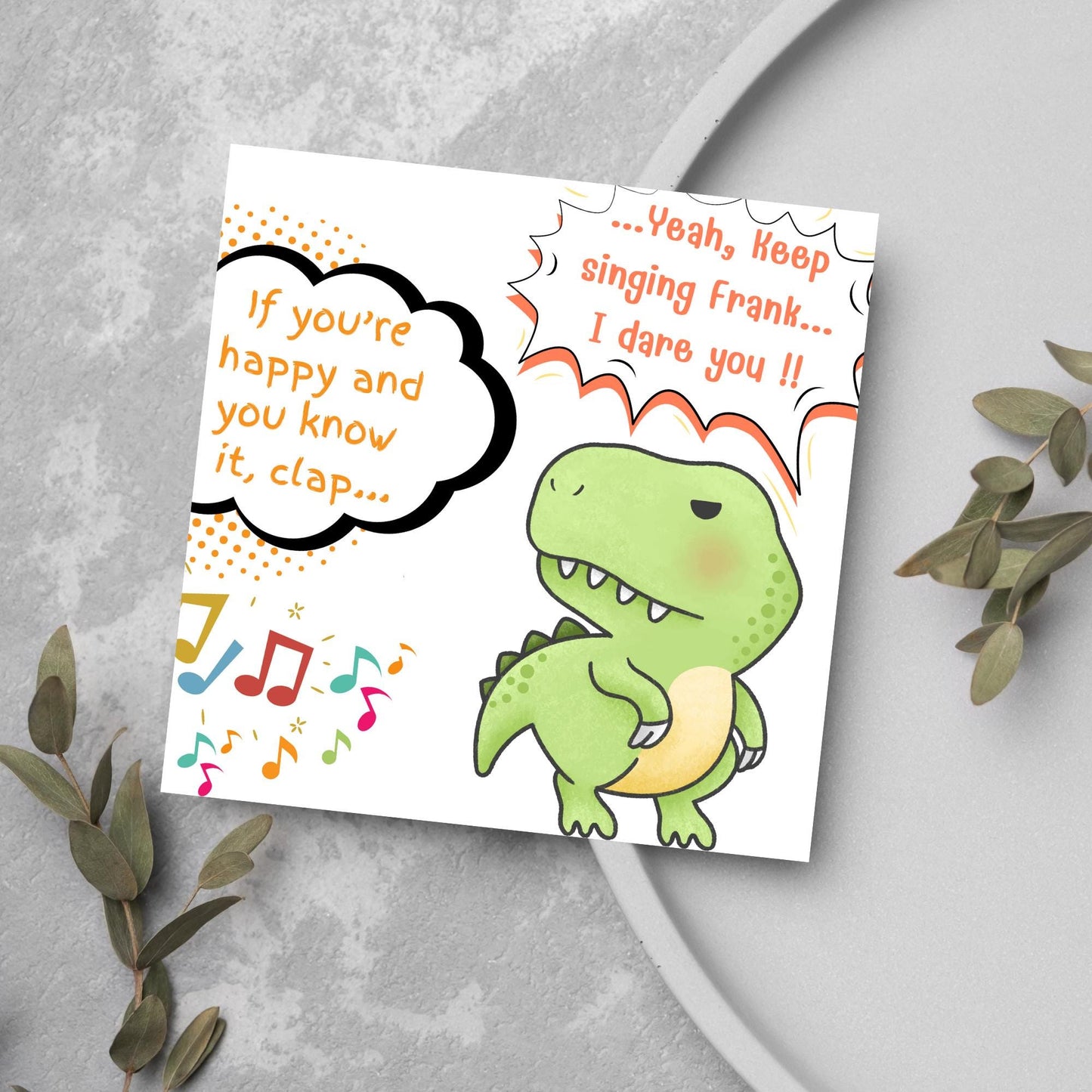 A cute, grumpy green T-Rex with tiny arms is featured. Text reads, "If you're happy and you know it, clap..." The T-Rex responds, "...Yeah, keep singing Frank... I dare you!!" Musical notes add a playful touch.