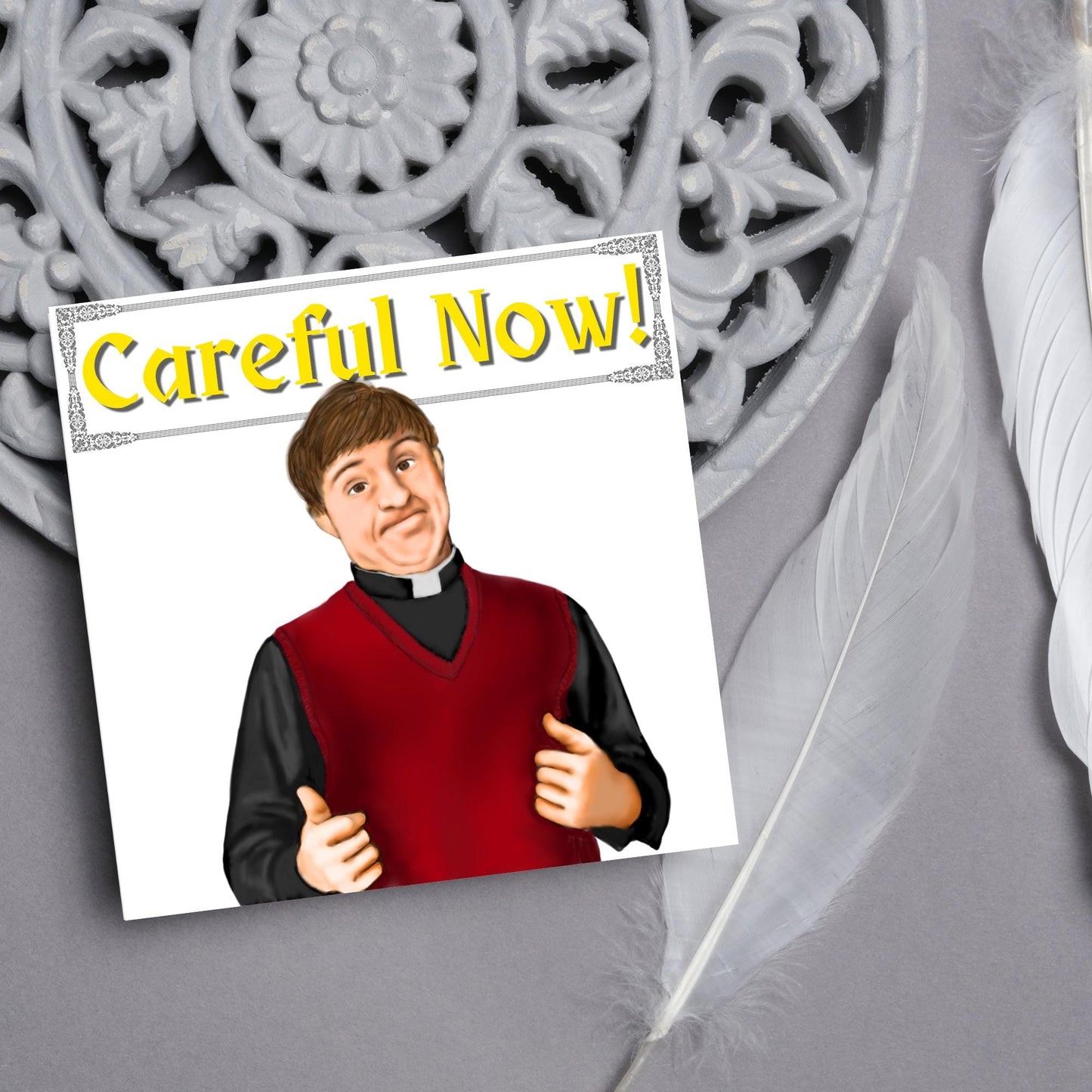 Square card with a hand drawn image of father dougal from the tv show father ted, with his thumbs up and a cheeky smile. At the top of the card is the text careful now in a similar style to the shows title