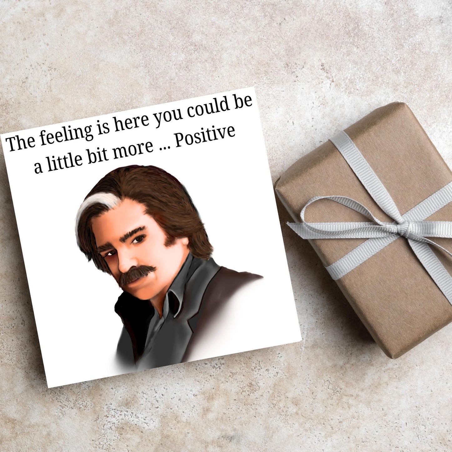 Square card with a hand drawn image of Steven Toast from the TV show Toast of London giving side eye with the text above - the feeling is here you could be a little bit more.....positive
