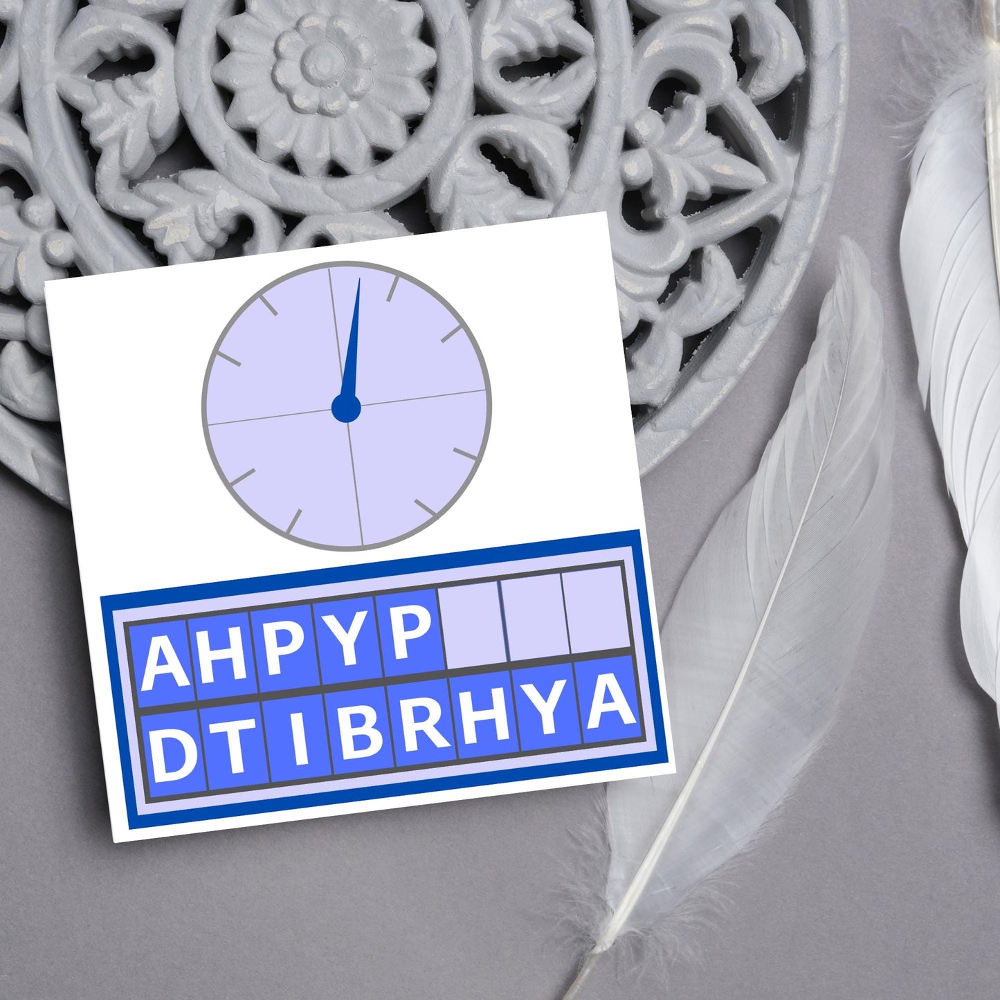 Square birthday card with a countdown theme with the clock and jumbled up letters that spell happy birthday