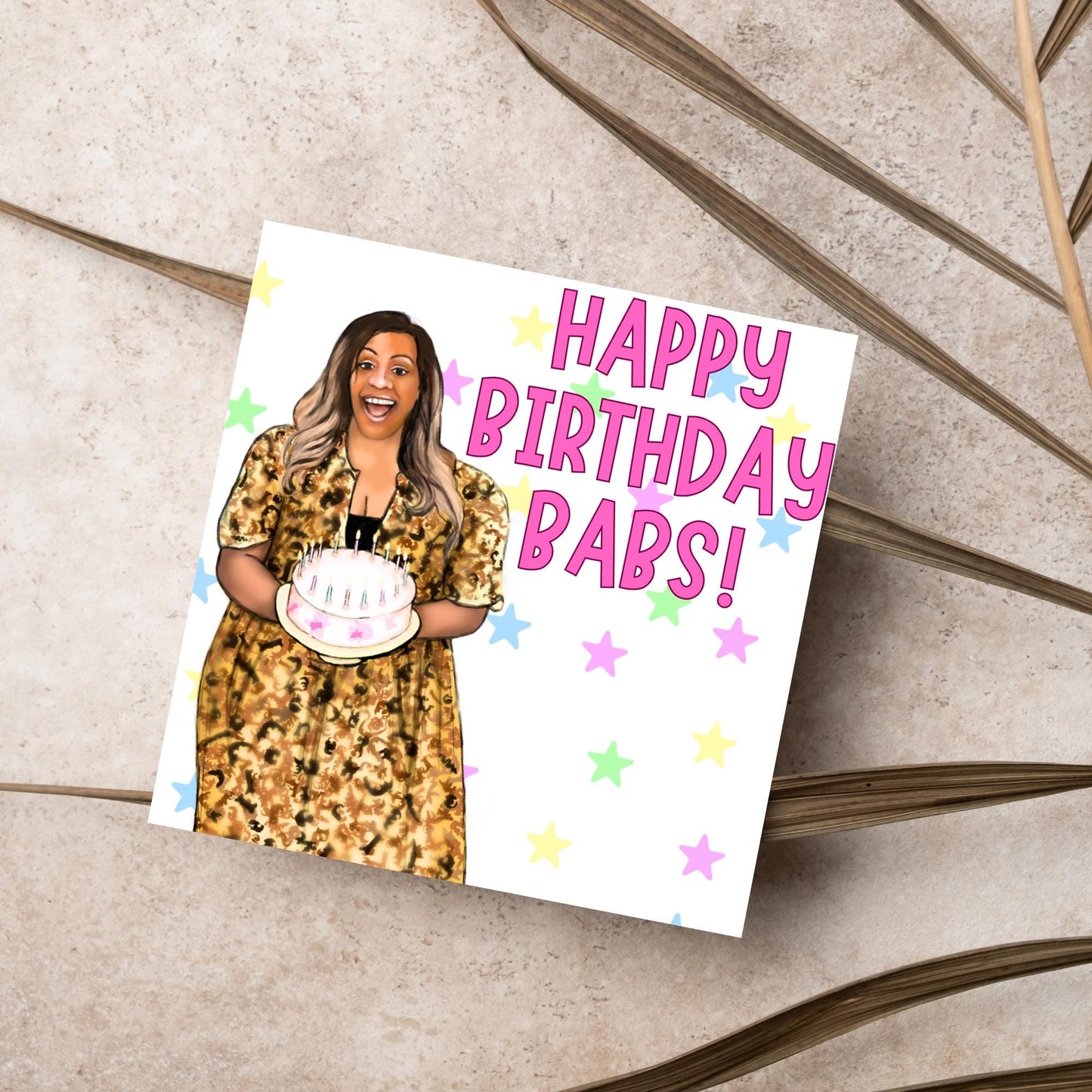 square card with a hand drawn image of Alison Hammond in a leopard print dress, holding a birthday cake and laughing joyfully with a background of multicoloured stars and Big pink text that reads HAPPY BIRTHDAY BABS!