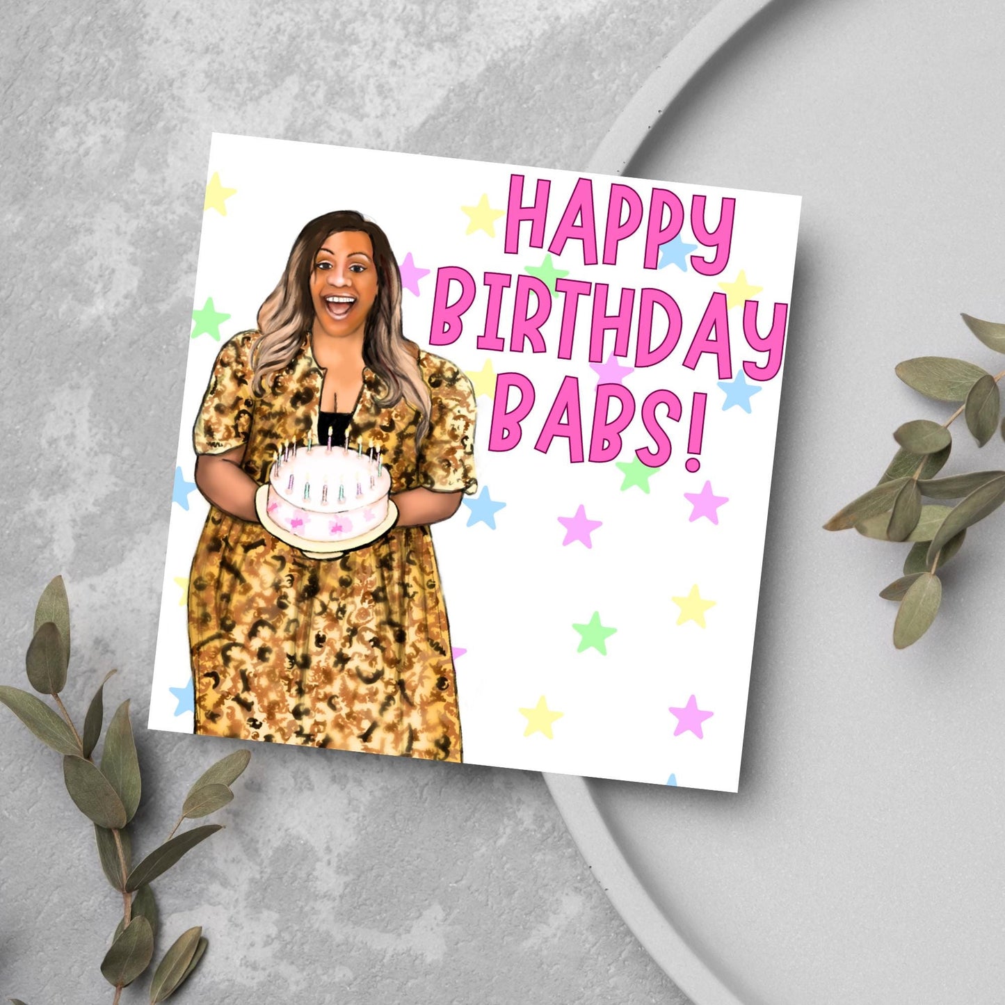 square card with a hand drawn image of Alison Hammond in a leopard print dress, holding a birthday cake and laughing joyfully with a background of multicoloured stars and Big pink text that reads HAPPY BIRTHDAY BABS!