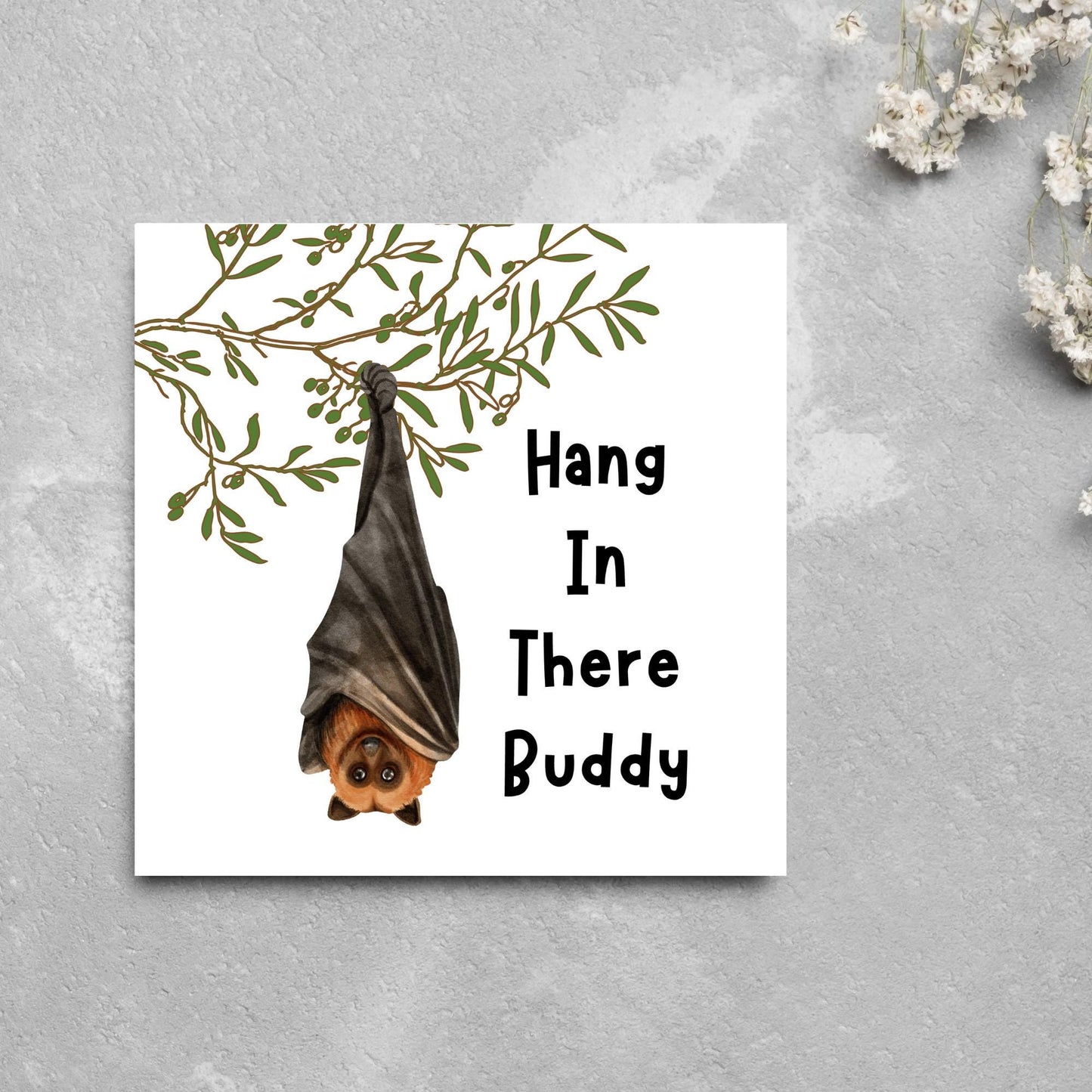 square card with an illustration of a bat hanging upside down from a tree branch with black text next to it that reads - Hang in there buddy