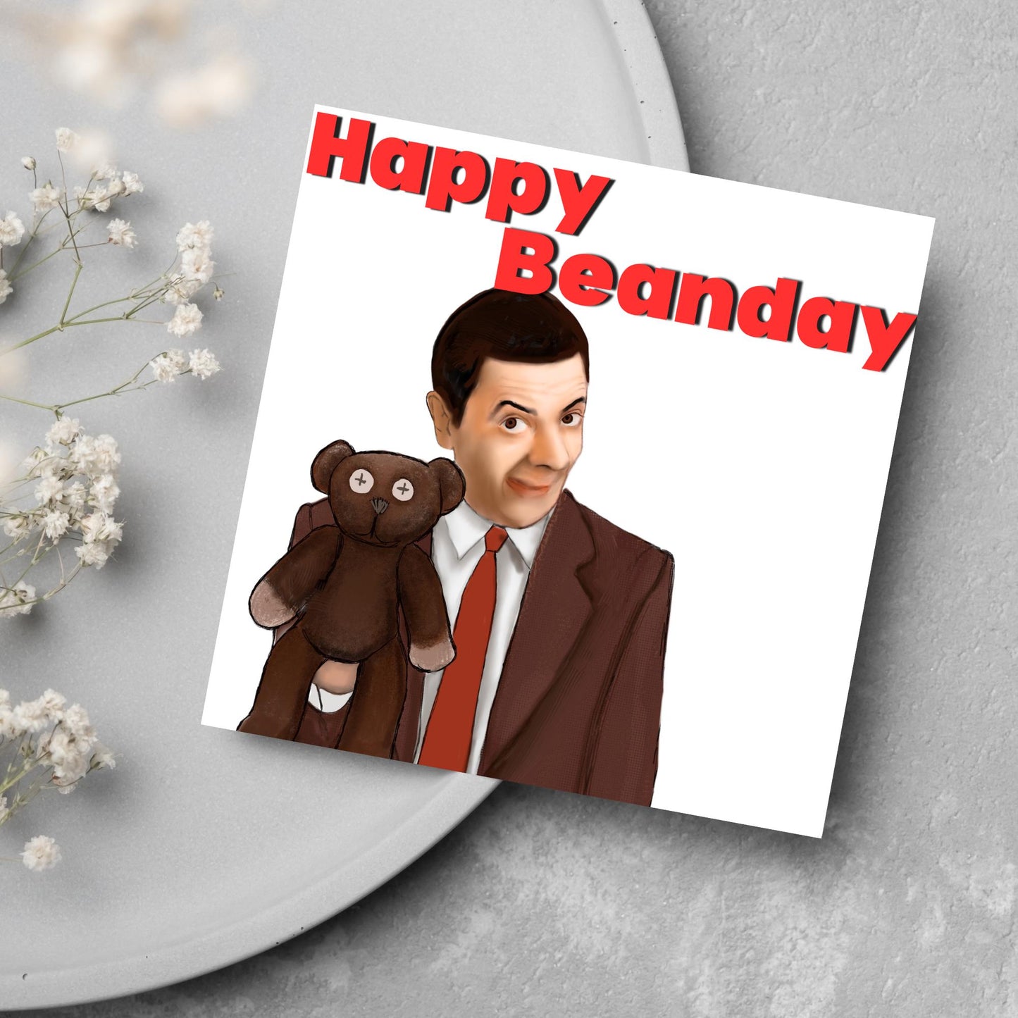 square card with a hand drawn image of Mr bean holding his teddy pooky with a cheeky smile on his face with the words Happy Beanday above in bold red text