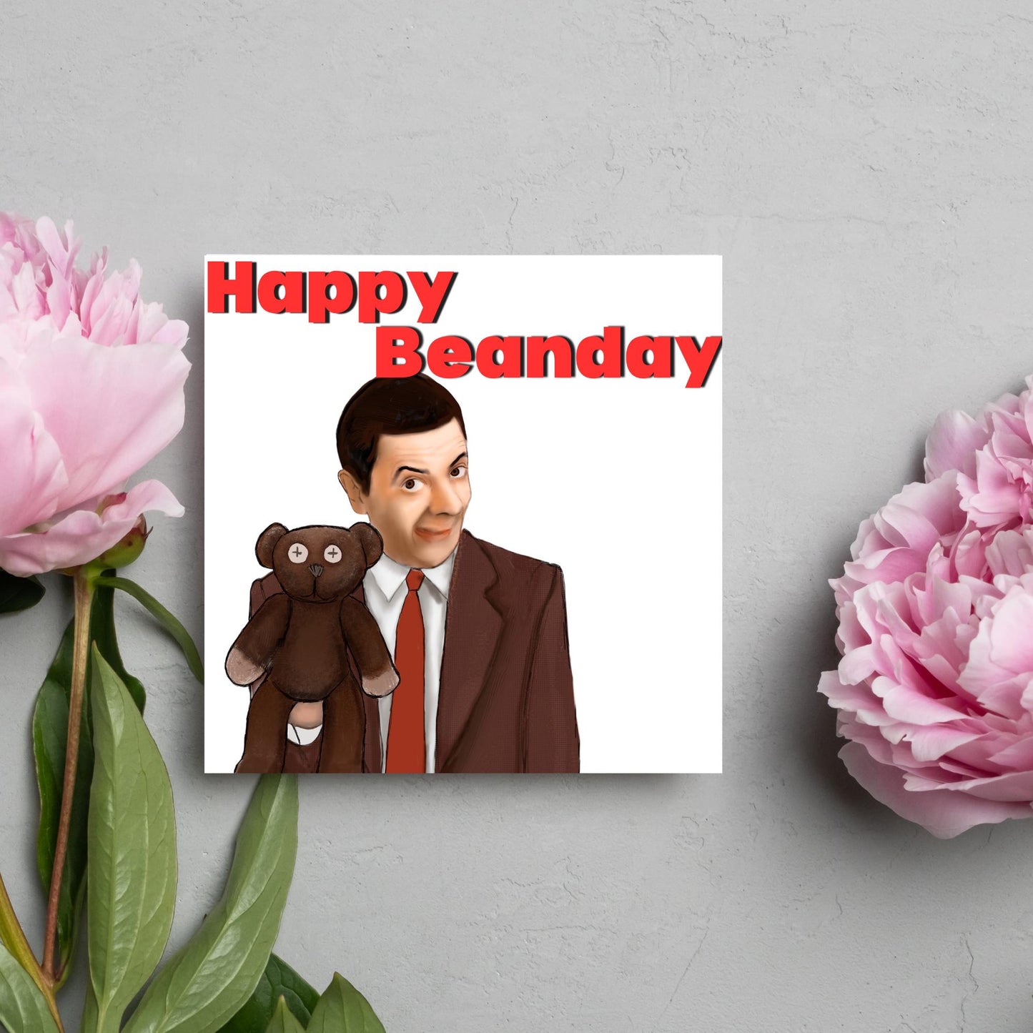square card with a hand drawn image of Mr bean holding his teddy pooky with a cheeky smile on his face with the words Happy Beanday above in bold red text