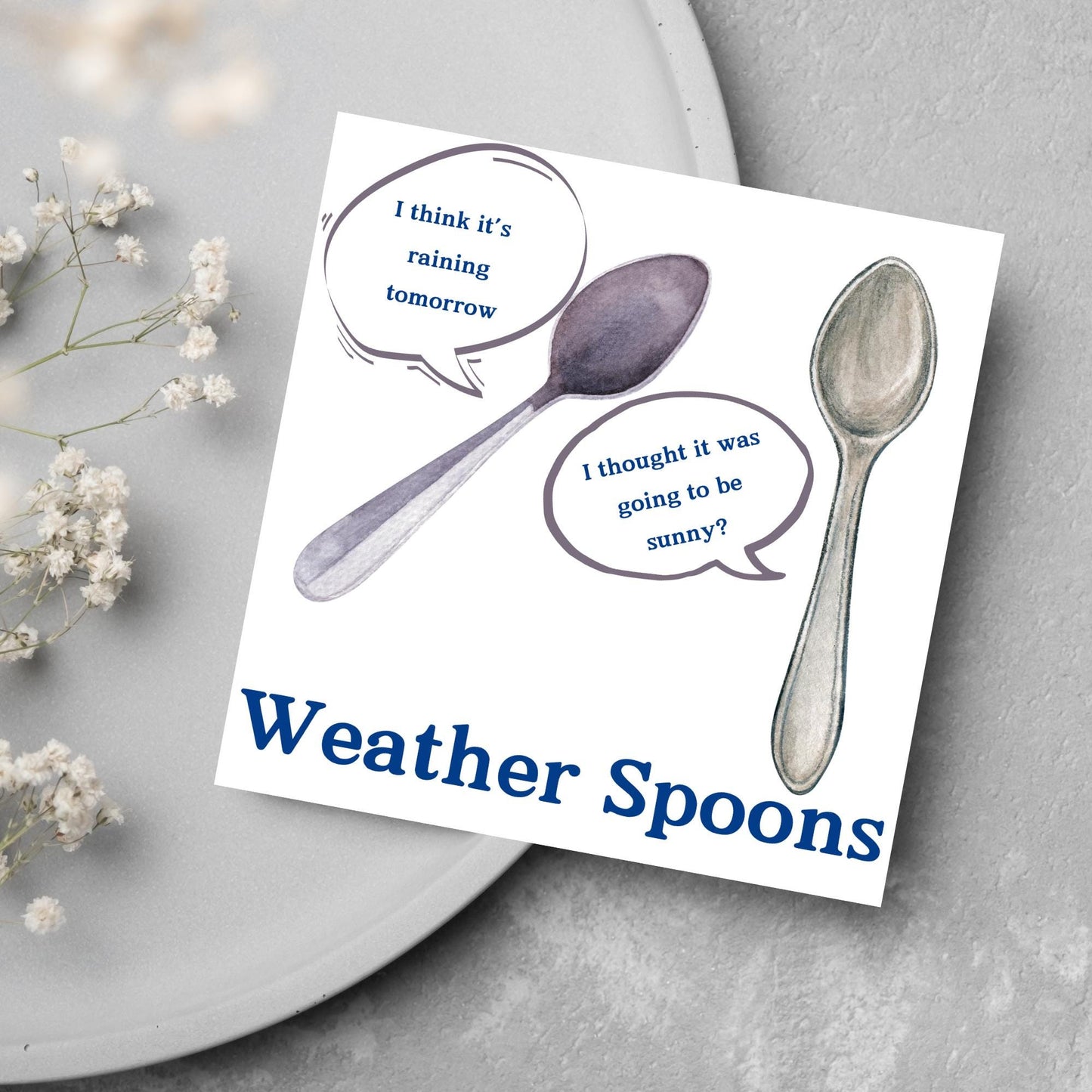 Image of a square greeting card. The card has a white backdrop with an illustration of two spoons with speech bubbles. One says I think it's raining tomorrow. The other says I thought it was going to be sunny? Underneath the illustration in a blue font is the text Weather Spoons