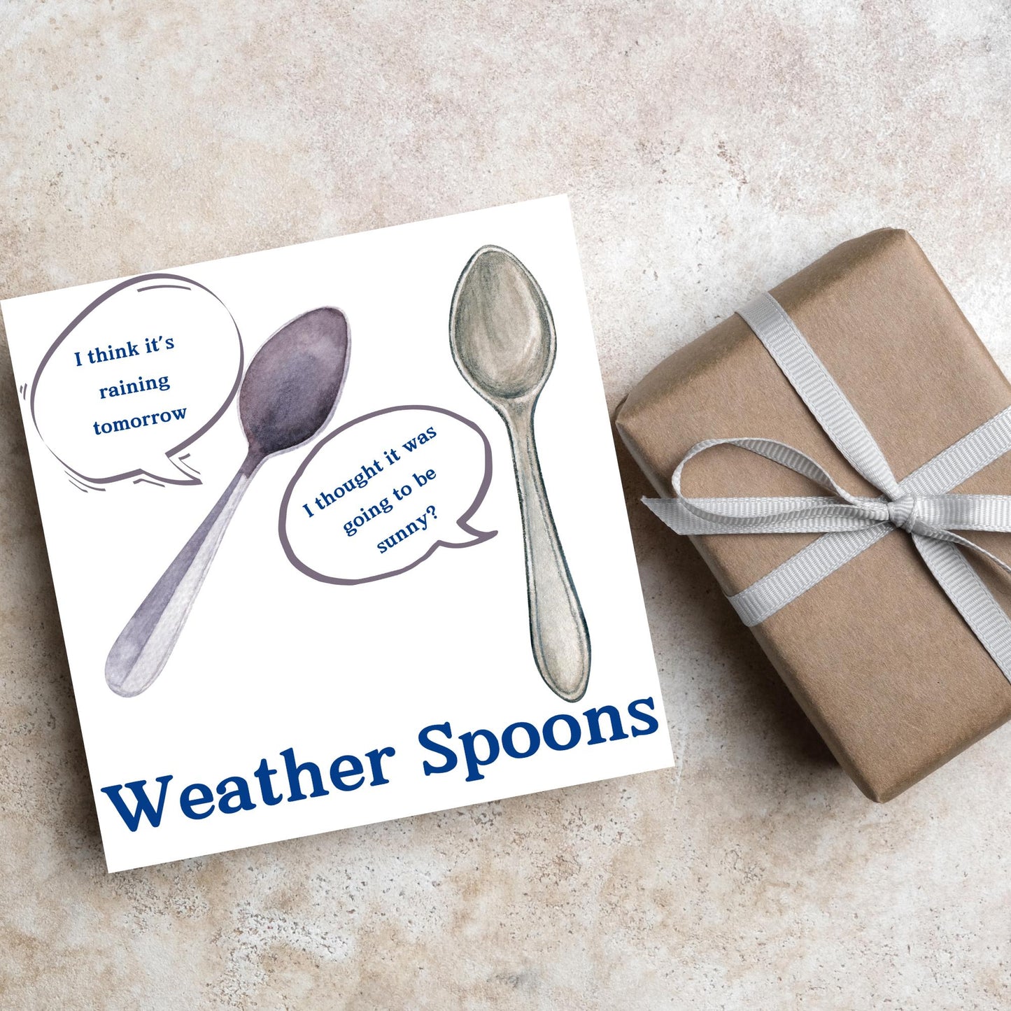 Image of a square greeting card. The card has a white backdrop with an illustration of two spoons with speech bubbles. One says I think it's raining tomorrow. The other says I thought it was going to be sunny? Underneath the illustration in a blue font is the text Weather Spoons