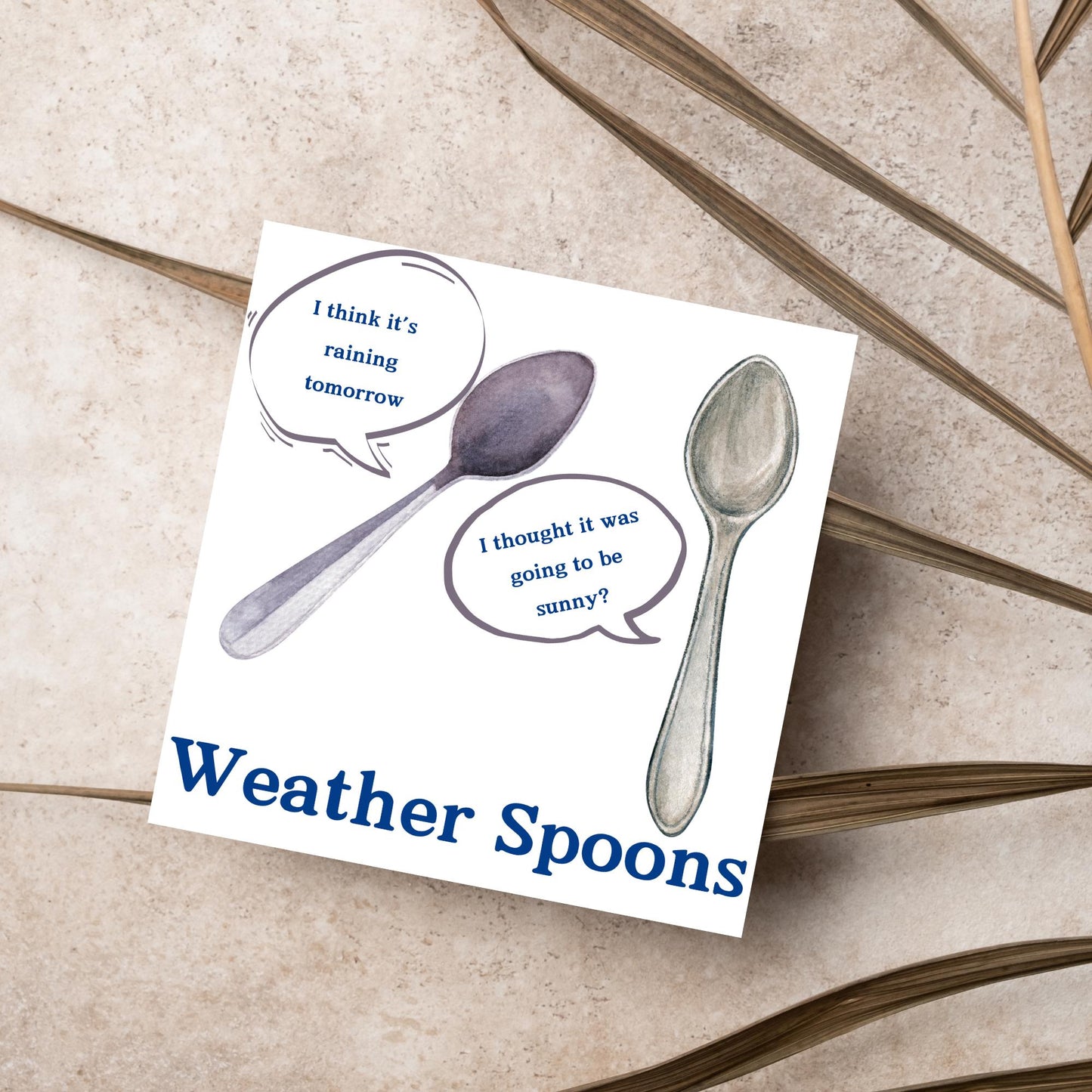 Image of a square greeting card. The card has a white backdrop with an illustration of two spoons with speech bubbles. One says I think it's raining tomorrow. The other says I thought it was going to be sunny? Underneath the illustration in a blue font is the text Weather Spoons