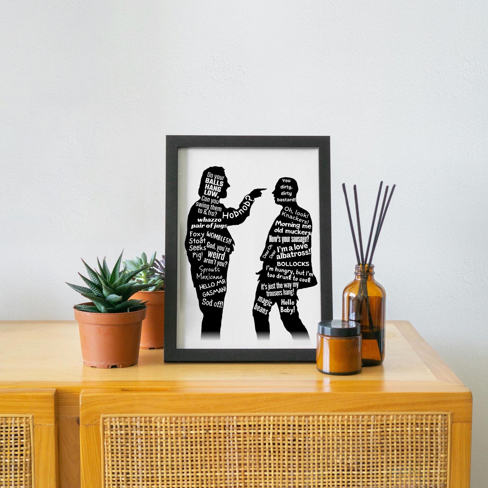 This A4 Poster print is in a simple black frame. The Print has two black silhouettes of Eddy and Richie from the hit BBC Comedy Bottom. Inside of the silhouettes has a selection of bottom quotes such as Do Your balls hang low, Can you swing them to & Fro. Hob Nob? WOMBLES, GASMAN, I'm Hungry but I am too drunk to cook. This poster print is perfect for any bottom fan.