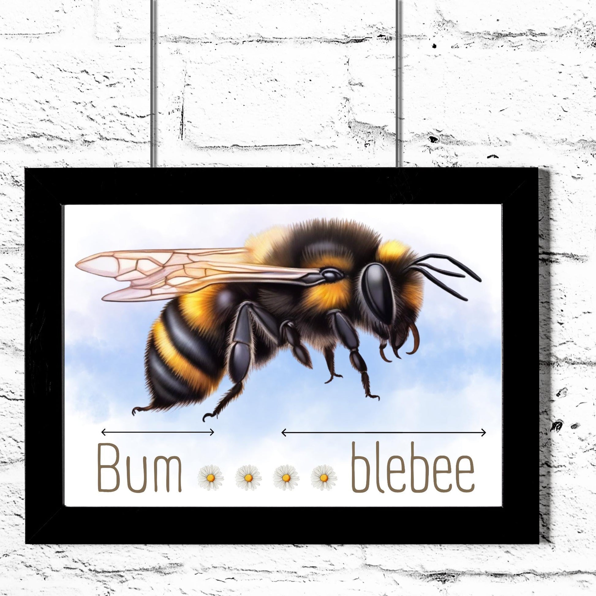 A framed A4 art print featuring a detailed illustration of a bumblebee with soft blue sky in the background. Below the bee, the text playfully reads "Bum" followed by five daisy icons and then "blebee," with arrows pointing across the entire phrase to emphasise the humorous, stretched-out pun