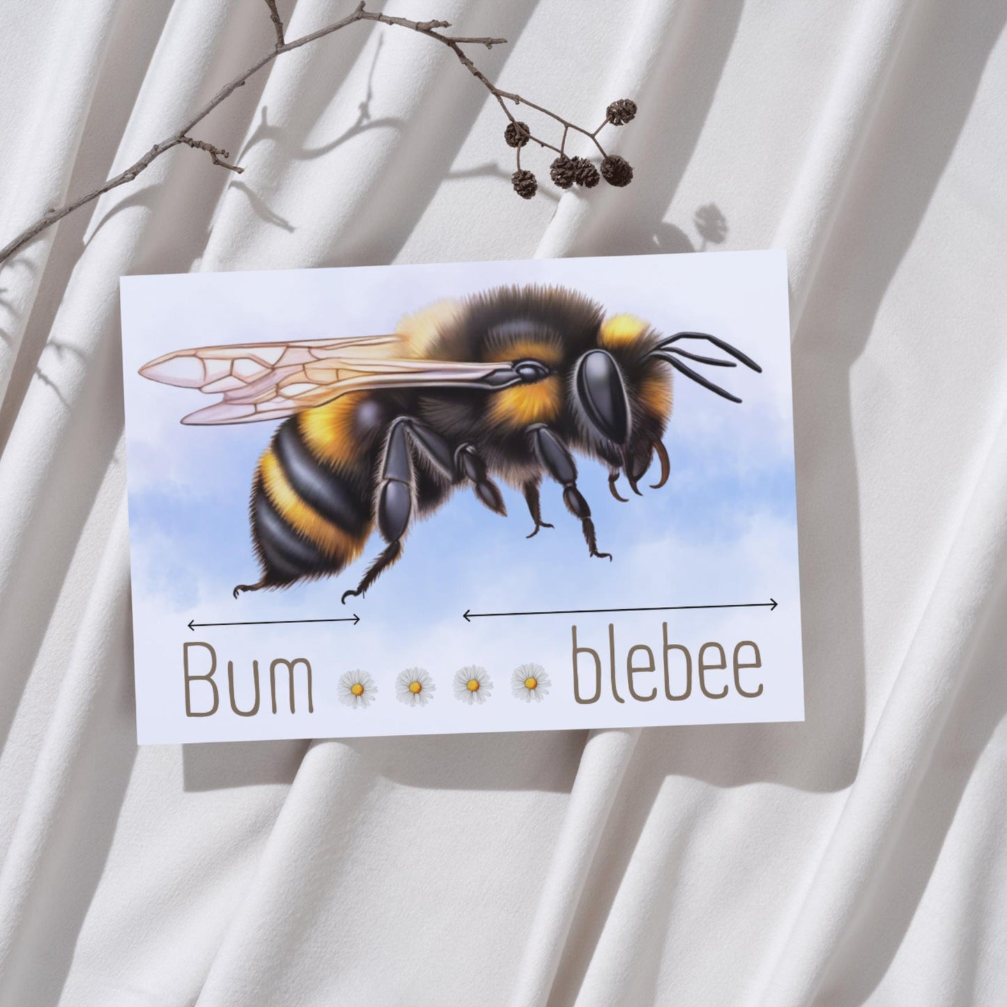 A framed A4 art print featuring a detailed illustration of a bumblebee with soft blue sky in the background. Below the bee, the text playfully reads "Bum" followed by five daisy icons and then "blebee," with arrows pointing across the entire phrase to emphasise the humorous, stretched-out pun